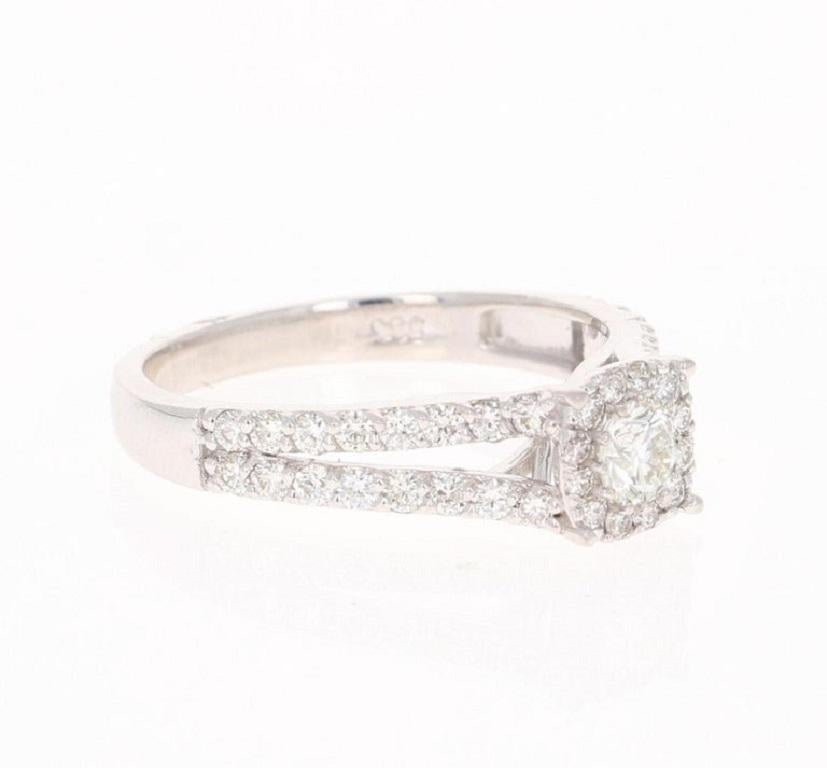 This ring has 45 Round Cut Diamonds that weigh 0.95 Carats. The Cluster setting makes the center Diamond look well over a carat. The Clarity is VS2 and the Color is H.

It is beautifully set in 14 Karat White Gold and weighs approximately 3.0