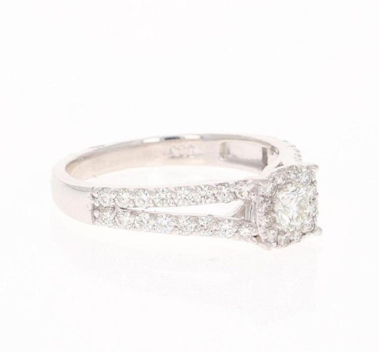 This ring has 45 Round Cut Diamonds that weigh 0.95 Carats. The Cluster setting makes the center Diamond look well over a carat. The Clarity is VS2 and the Color is H.

It is beautifully set in 14 Karat White Gold and weighs approximately 3.0