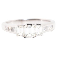 0.95 Carat Emerald Cut Diamond Three Stone Engagement Ring in 18 Carat Gold