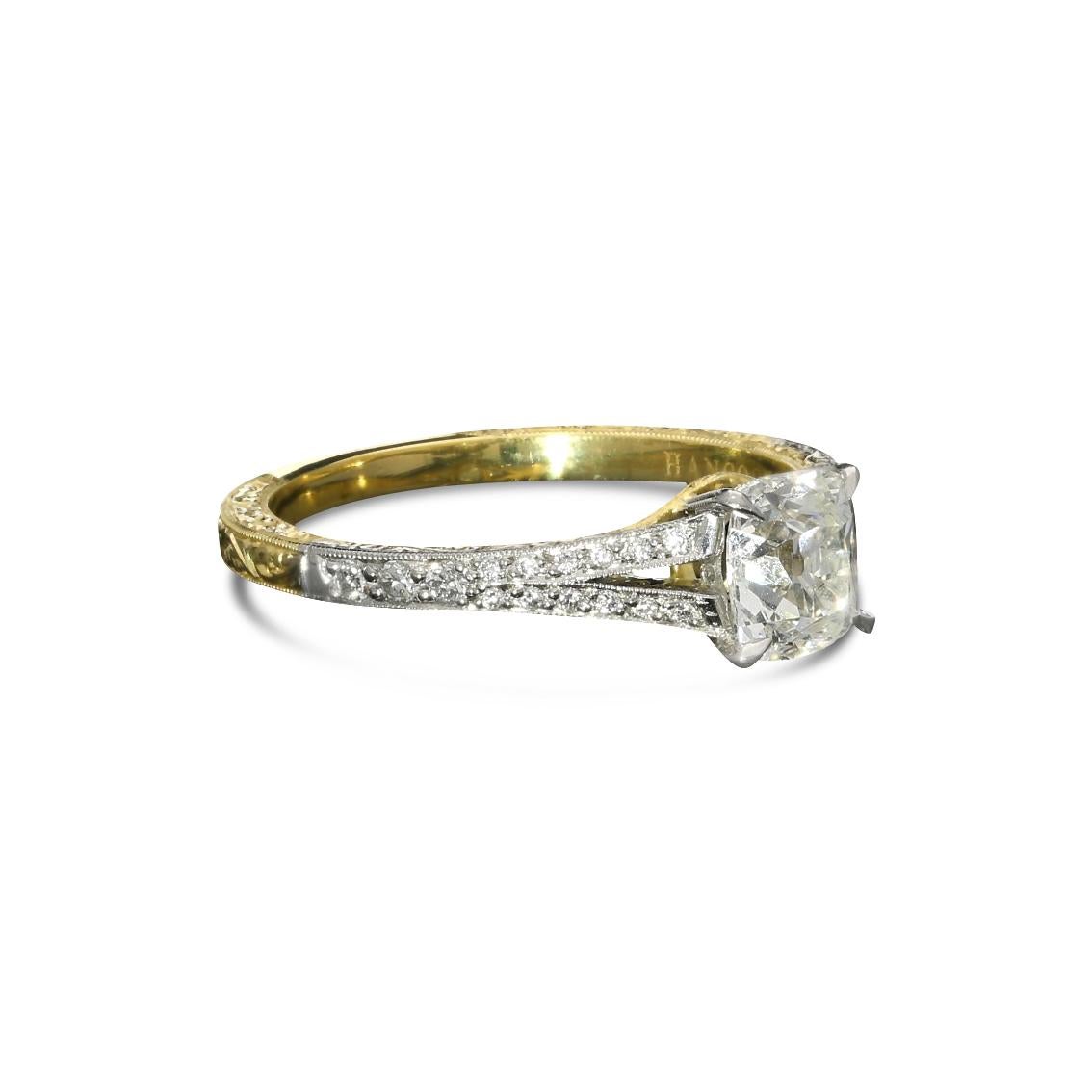 An elegant old cut diamond, platinum and 18ct yellow gold ring by Hancocks, centred with a beautiful cushion shaped old mine brilliant cut diamond weighing 0.95cts and of K colour and VS1 clarity, claw set in platinum between split tapering