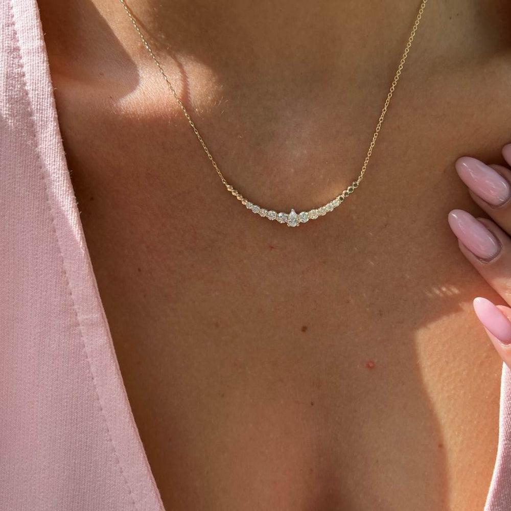 0.95 Carat Pear and Round Diamond Necklace in 14K Yellow Gold, Shlomit Rogel

Captivating in design, this dainty necklace is a true beauty. Designed in 14k yellow gold, the Lor necklace features a special combination of round diamonds of different