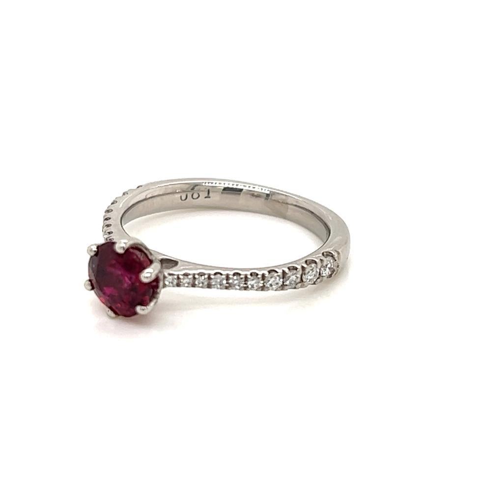 0.95 Carat Round Brilliant Ruby and Diamond Ring in Platinum.

This timeless ring features a stunning round brilliant Ruby held in a dainty six-claw setting on a Diamond encrusted Platinum band.

The resplendent Ruby sitting in the spotlight on this