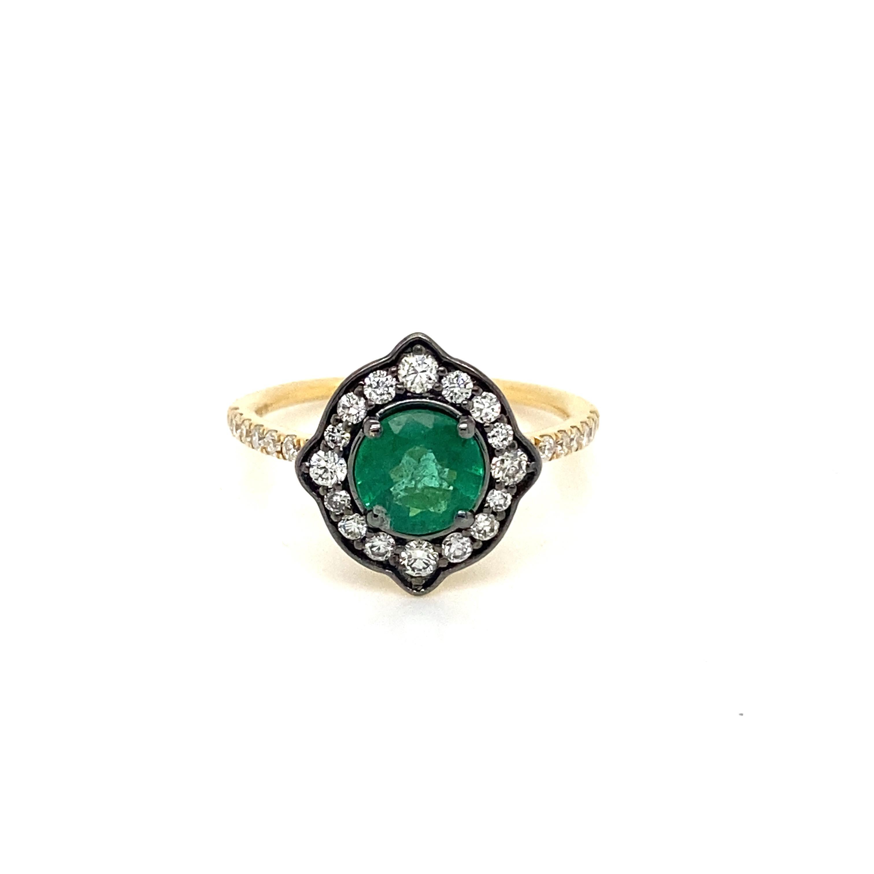 This stunning Cocktail Ring features a beautiful 0.95 Carat Round Emerald surrounded by Radiant Round White Diamonds, that sits on a Diamond Shank. This Ring is set in 18K Yellow Gold. Total Diamond Weight = 0.48 carats. Ring Size is 6 1/2.