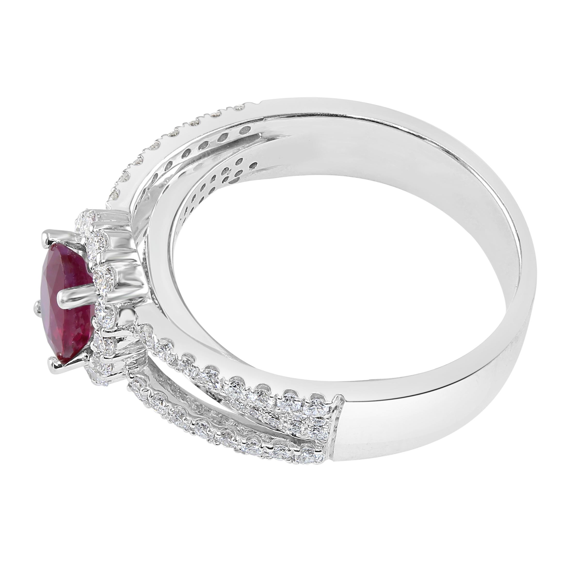 Gorgeous 0.95 carat Oval Ruby, surrounded by a diamond halo. 

Total diamond weight: 0.63 carat.

Set in 18K White Gold.

This vivid Ruby is a stunning one-of-a-kind option for a unique engagement ring. May also be worn as a beautiful right-hand
