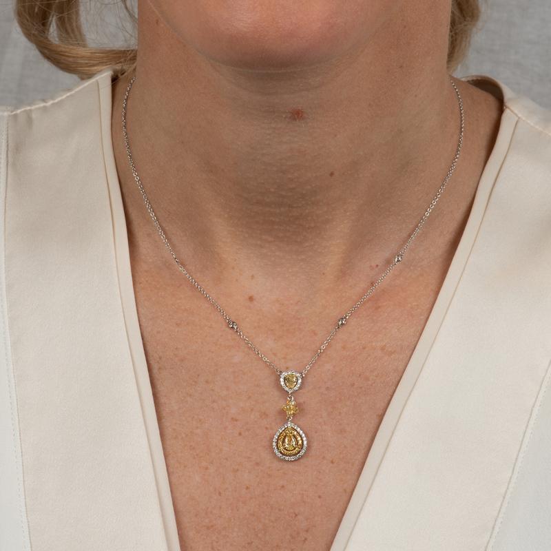 This delicate but beautiful necklace features 0.95 carat total weight in natural fancy yellow and white diamonds set in 18 karat gold on a diamond by the yard style chain. Lobster clasp closure with adjustable chain. 
Measurements: 16