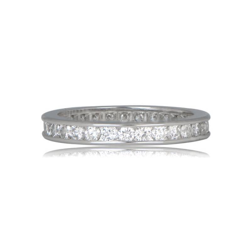 A stunning platinum and diamond eternity wedding ring, adorned with diamonds along the perimeter, showcasing a total approximate carat weight of 0.95 carats. The diamonds exhibit a beautiful H color and impeccable VS1 clarity, radiating brilliance.