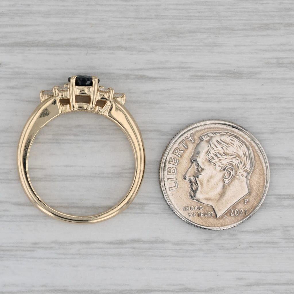 Gemstone Information:
- Natural Sapphire -
Carats - 0.70ct
Cut - Round 
Color - Dark Blue
Treatment - Heated

- Natural Diamonds -
Total Carats - 0.25ctw
Cut - Round Brilliant
Color - G - H
Clarity - SI2 - I1 

Metal: 14k Yellow Gold
Weight: 4.5