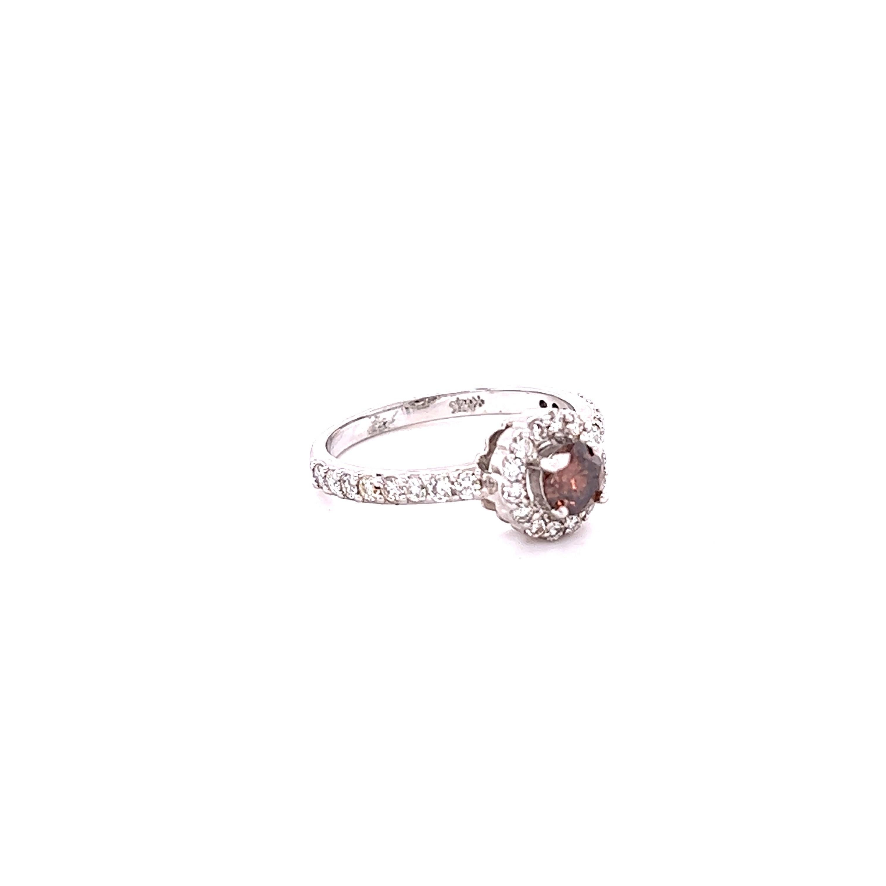 This beauty has a Round Cut Natural Brown Diamond that weighs 0.42 Carats and is surrounded by  30 Round Cut Diamonds that weigh 0.54 carats. The total carat weight of the ring is 0.96 carats. 

The ring is curated in 14 Karat White Gold and weighs