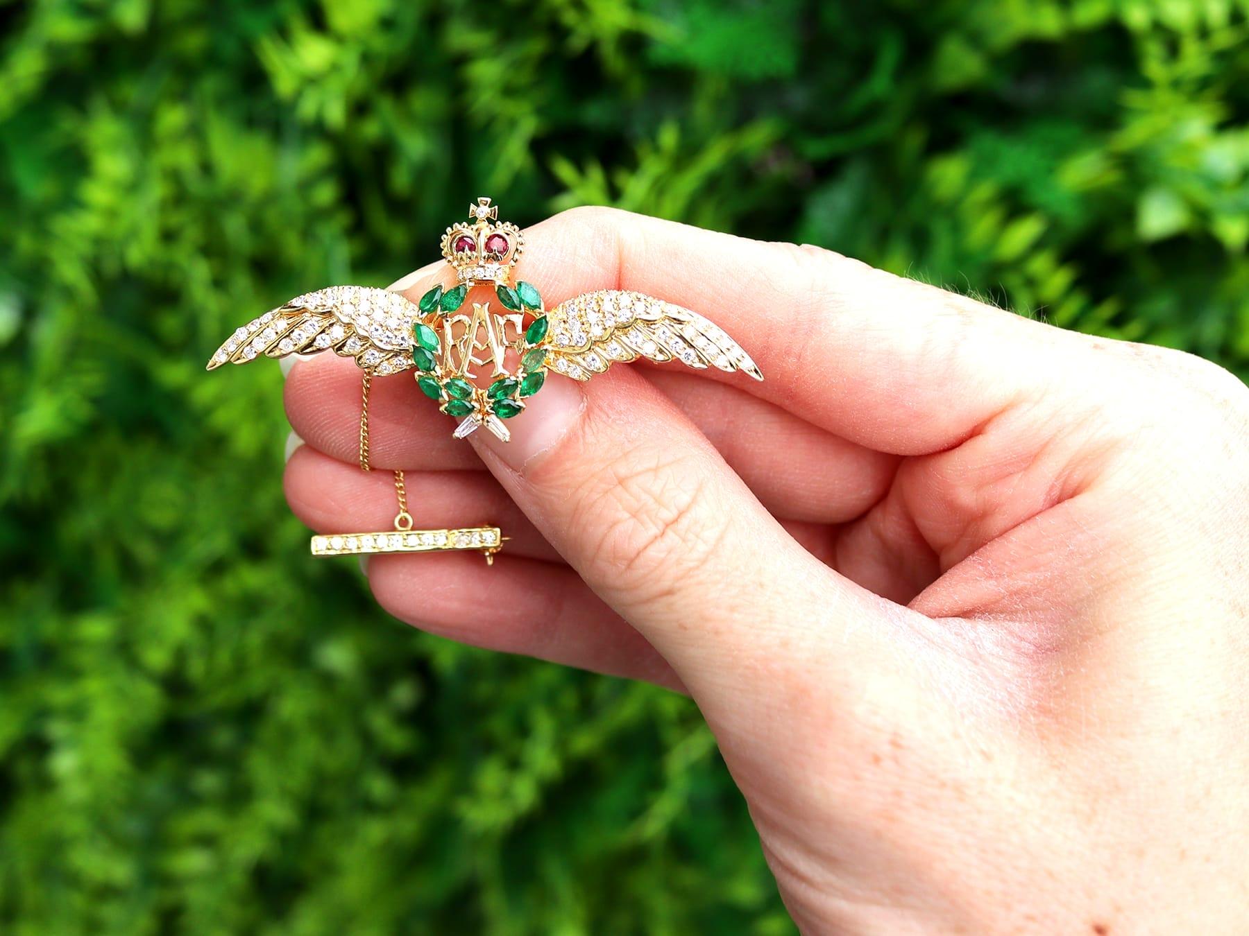 A fine and impressive vintage 0.96 carat emerald, 0.07 carat ruby and 0.78 carat diamond, 18 karat yellow gold RAF brooch; part of our collection of sweetheart brooches.

This stunning, fine and impressive vintage brooch has been crafted in 18k