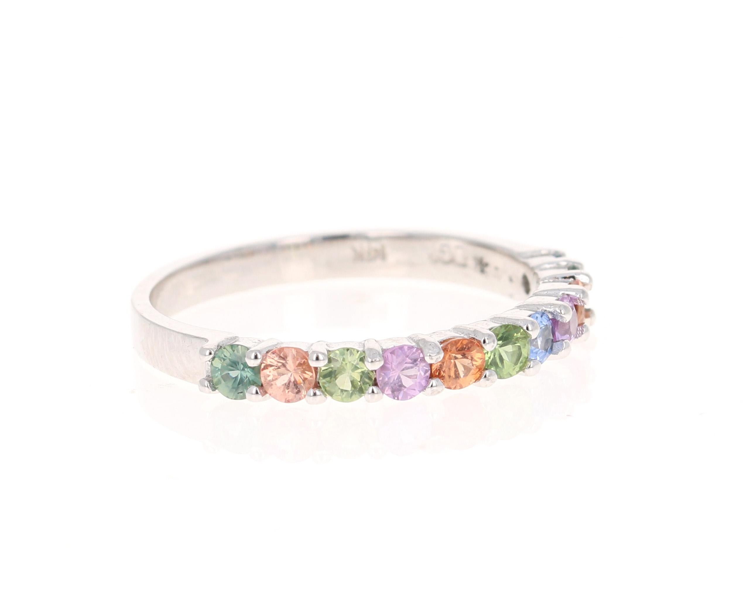 There are 11 Multicolored Genuine Sapphires in this band that weigh 0.96 Carats.  
It is perfect for everyday wear and looks amazing stacked or alone.  They are versatile and can jazz up to any outfit and occasion!  
This band is created in 14 Karat