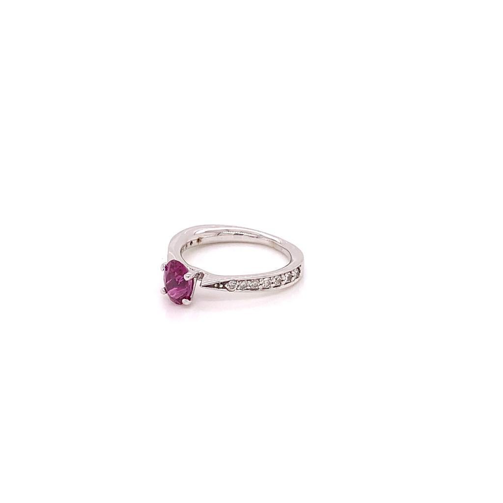 The Hot Pink Oval Sapphire weighing approximately 0.96 carats at the centre of this Gorgeous ring is claw set in 18K White Gold and surrounded by Brilliant Shoulder Diamonds weighing approximately 0.22 carats. 

Elegantly beautiful, this ring is a