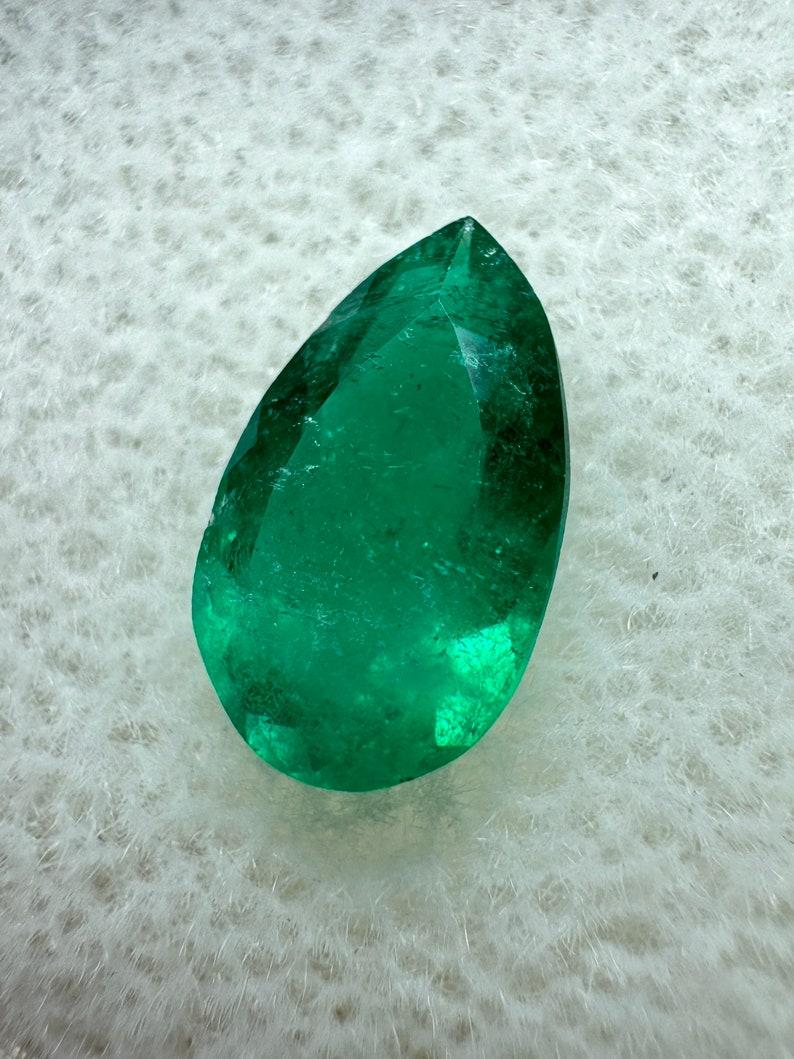 Stone: Emerald
Weight: 0.96-carats
Shape: Pear Cut
Clarity: Transparent
Luster: Very Good
Color: Muzo Green
Measurements: 9.44mm x 5.66mm x 3.26mm
Geographic Origin: Colombia
Treatment: Natural, Oiling

Comments: Due to their growth conditions in