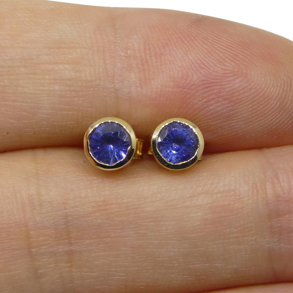 Contemporary 0.96ct Round Blue Sapphire Stud Earrings set in 14k Yellow Gold For Sale