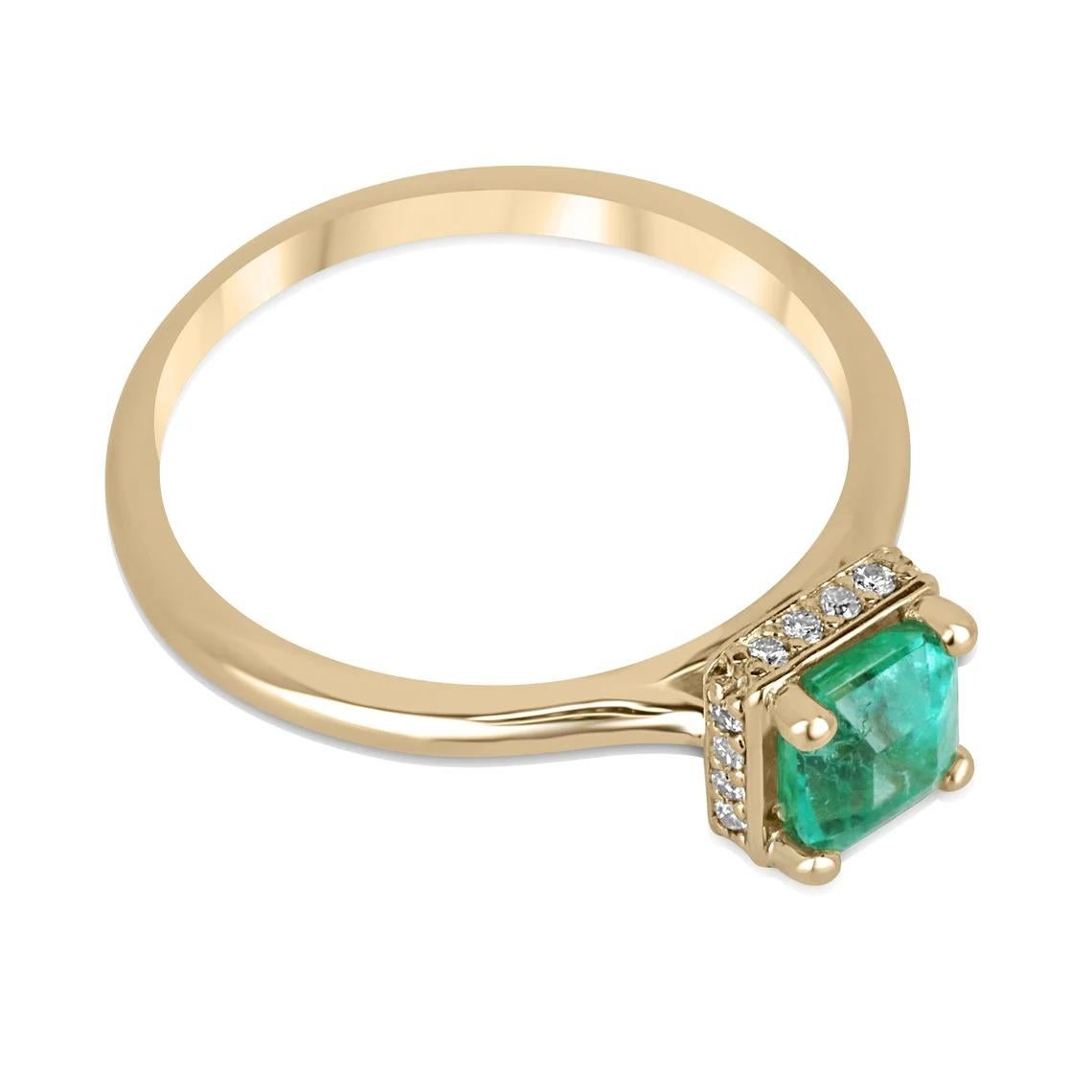 This stunning emerald and diamond ring features a gorgeous 0.80-carat asscher cut emerald sourced from Zambia. The emerald is set in a four-prong setting that showcases its unique cut and vibrant green color. The ring also boasts a hidden diamond