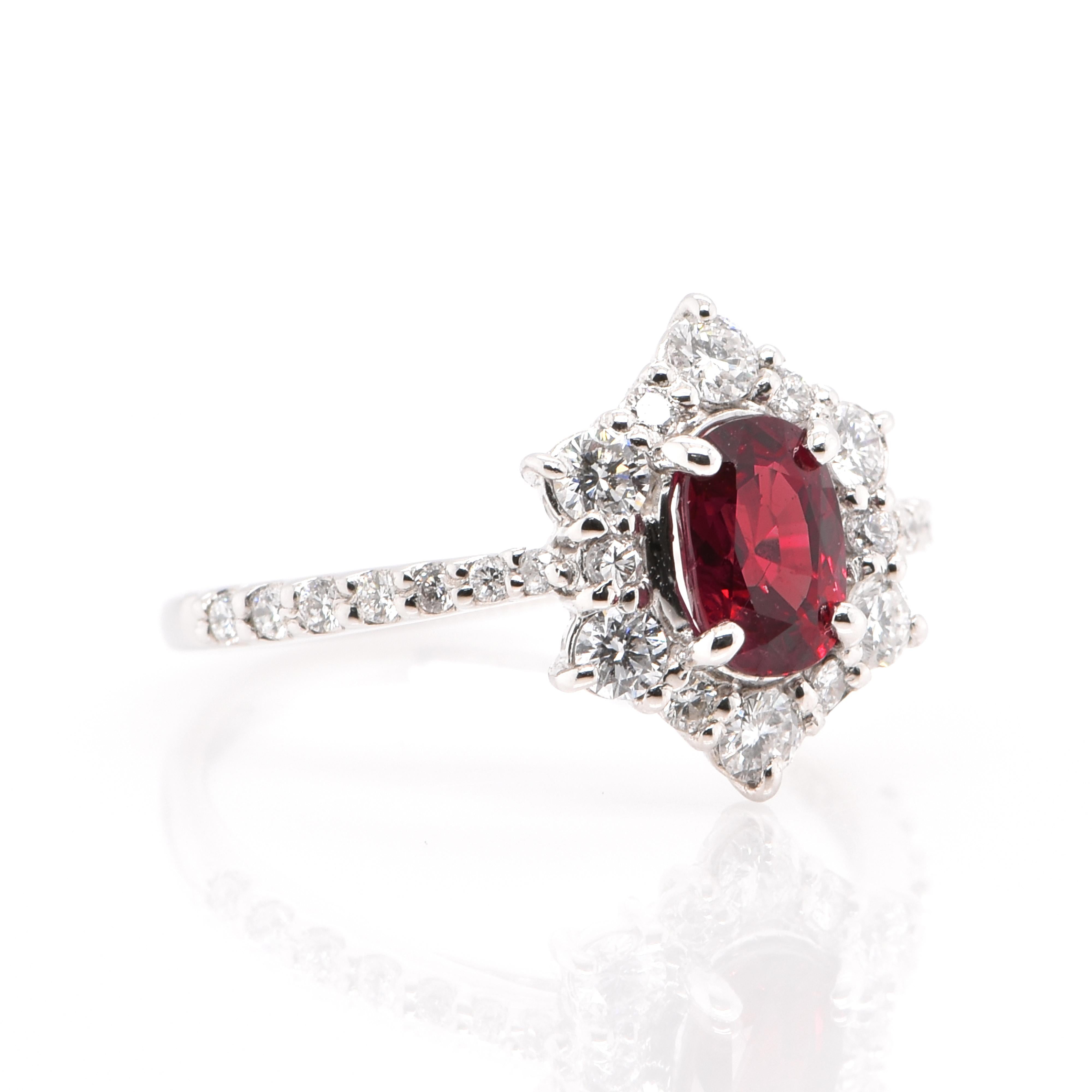 A beautiful Engagement Halo Ring featuring a 0.97 Carat, Natural Ruby and 0.48 Carats of Diamond Accents set in Platinum. The Ruby displays really exceptional luster and color. Rubies are referred to as 