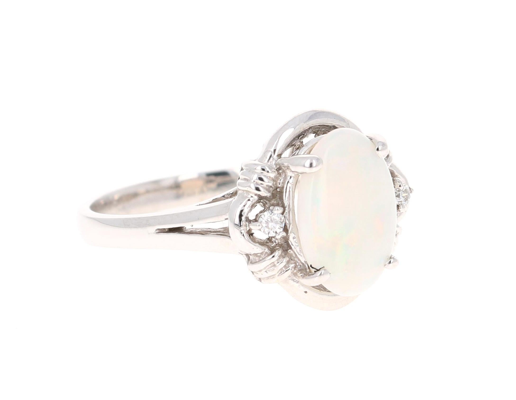 This ring has a cute and simple 0.93 Carat Opal and has 2 Round Cut Diamonds that weigh 0.04 Carats. The total carat weight of the ring is 0.97 Carats. 

The Opal displays beautiful flashes of yellow, green & orange and has its origins from
