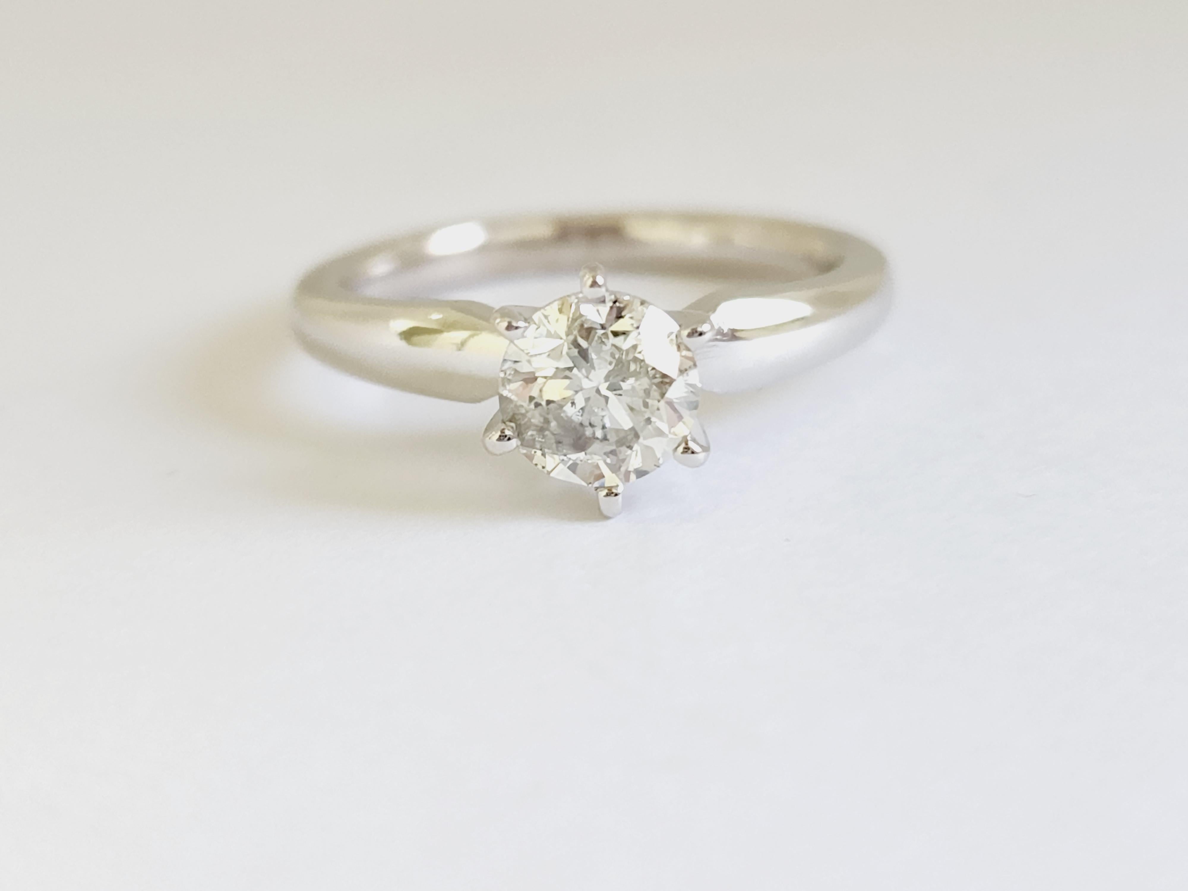 0.97 ct round brilliant cut natural diamonds. 6 prong solitaire setting, set in 14k white gold. Ring Size 6.5.
