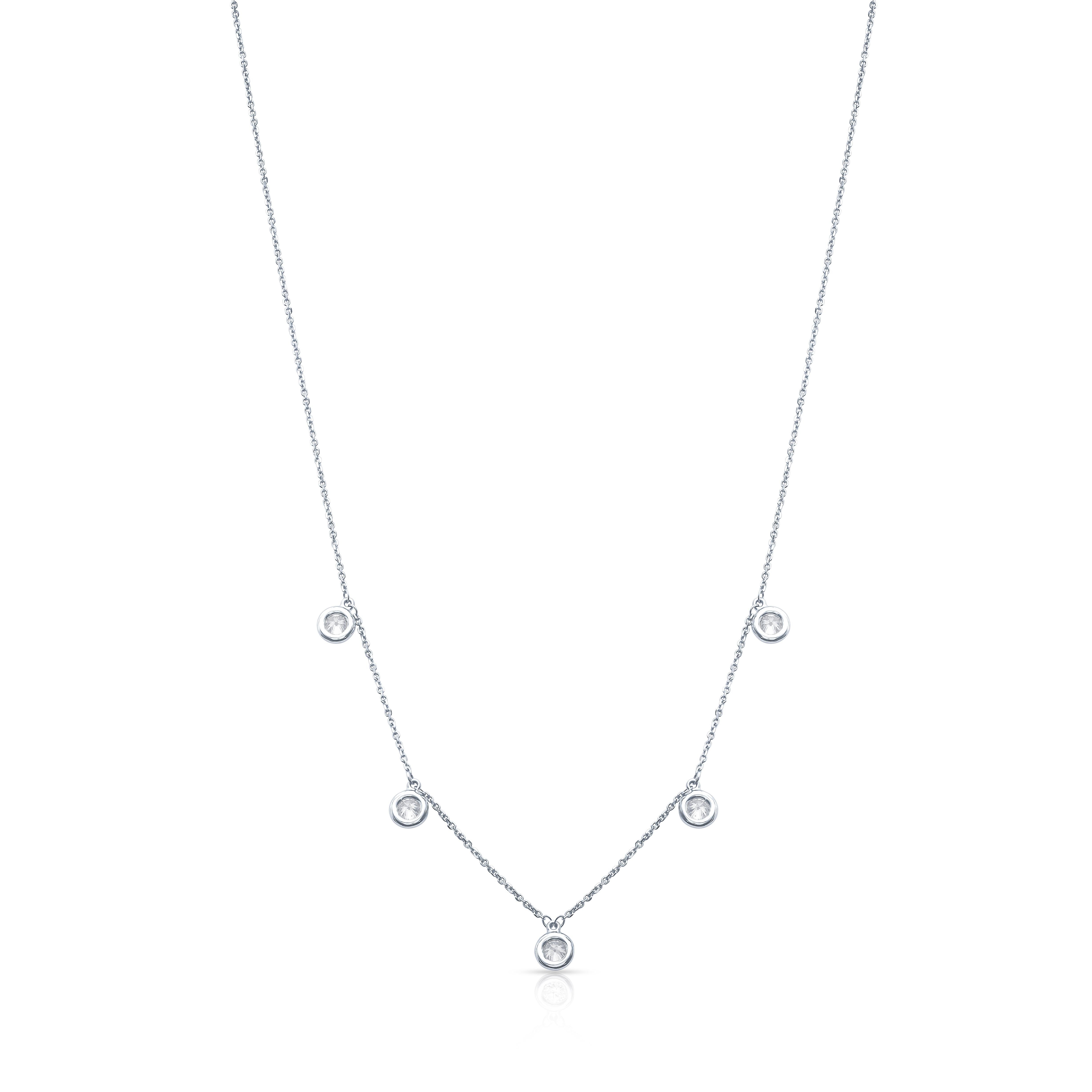 A very fine diamonds by the yard style necklace in 14 karat white gold comprised of five round diamonds, approx. 0.97 ctw, bezel set every 1