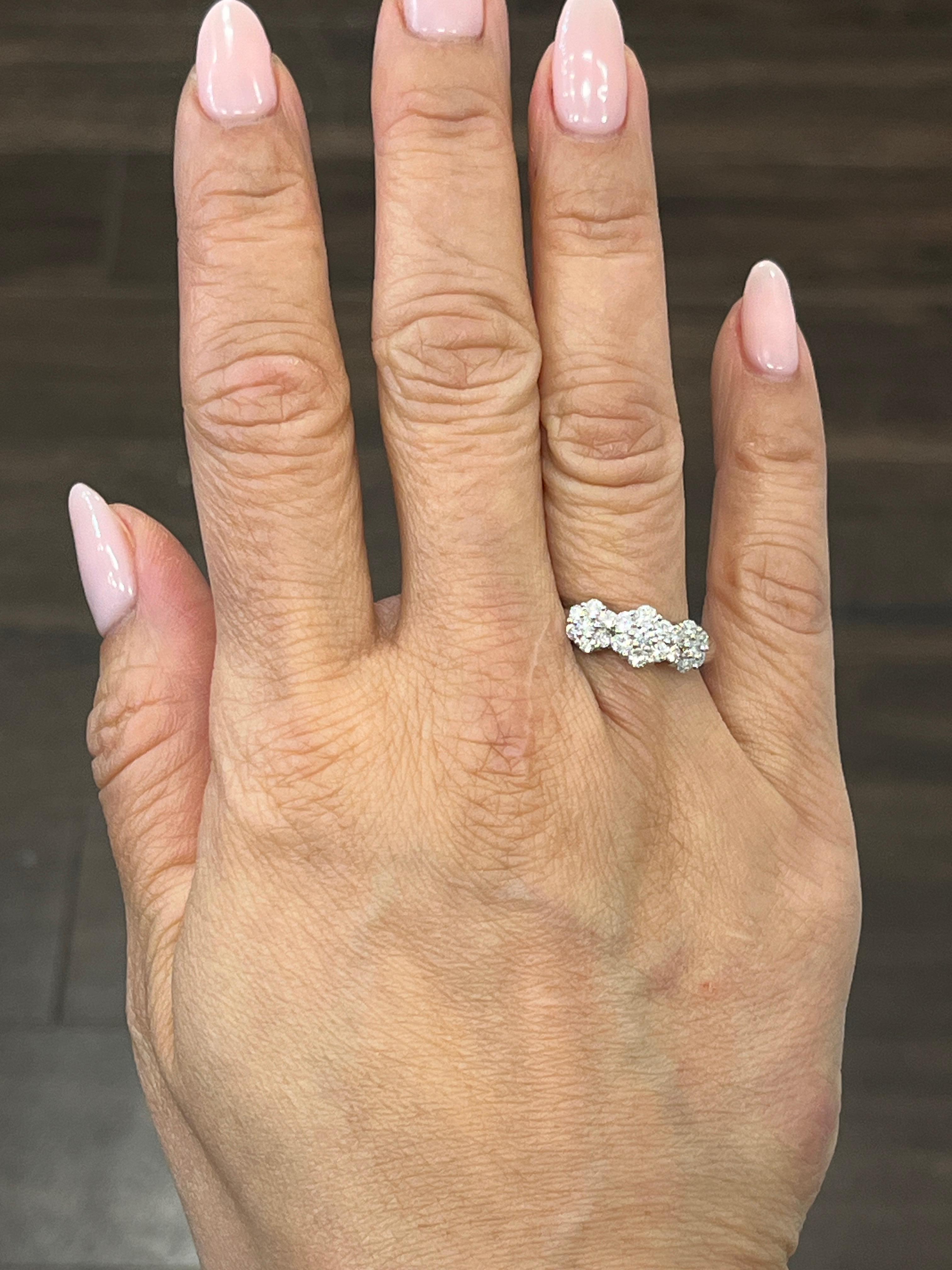 This stunning 18k white gold ring boasts 21 sparkling round diamonds with a total carat weight of 0.97. The diamonds have a clarity grade of VS2/SI1 and a color grade of F/G, making them a brilliant white. The ring is size 6.5 and can be adjusted as