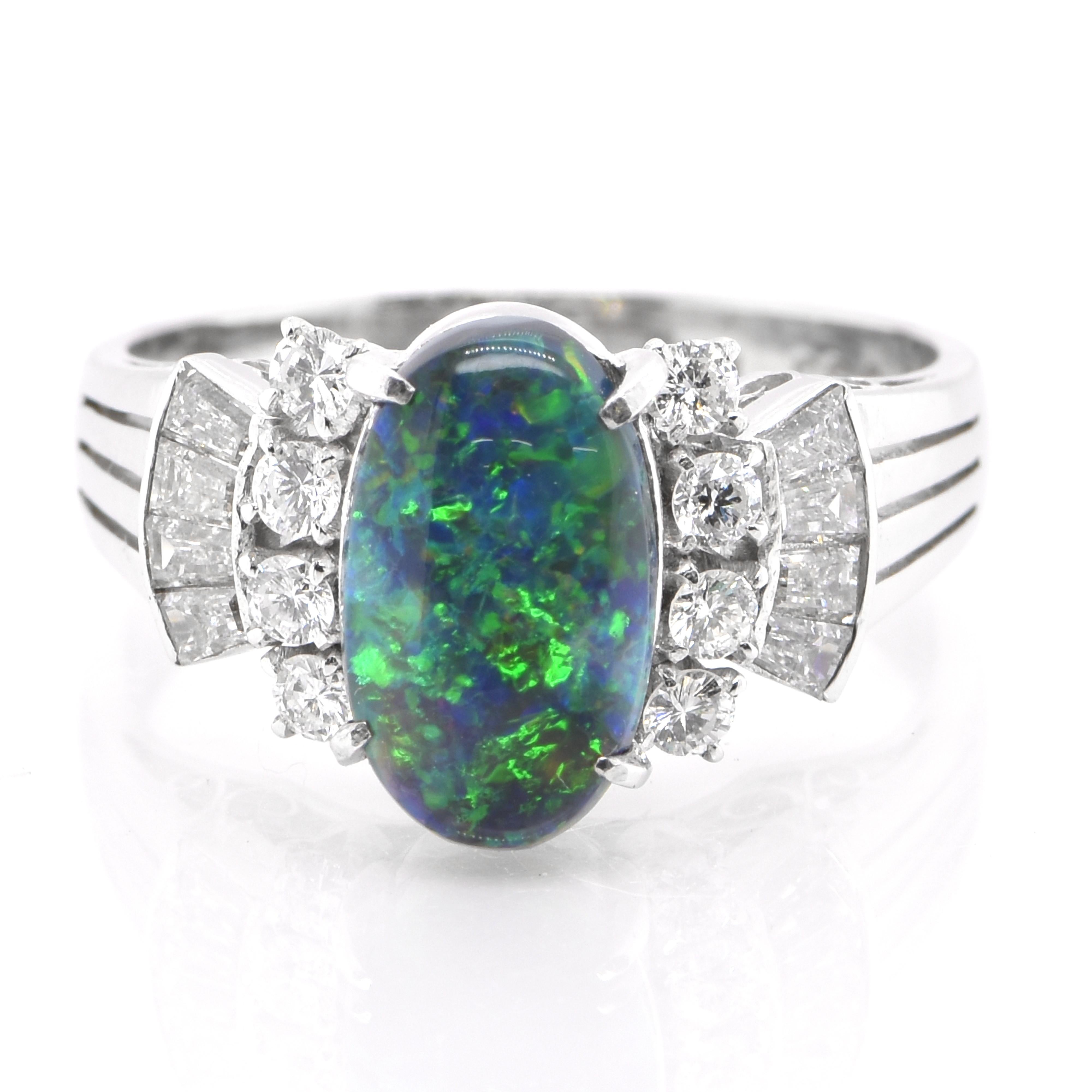 A beautiful ring featuring a 0.98 Carat, Natural, Australian Black Opal and 0.35 Carats of Diamond Accents set in Platinum. The Opal displays very good play of color! Opals are known for exhibiting flashes of rainbow colors known as 