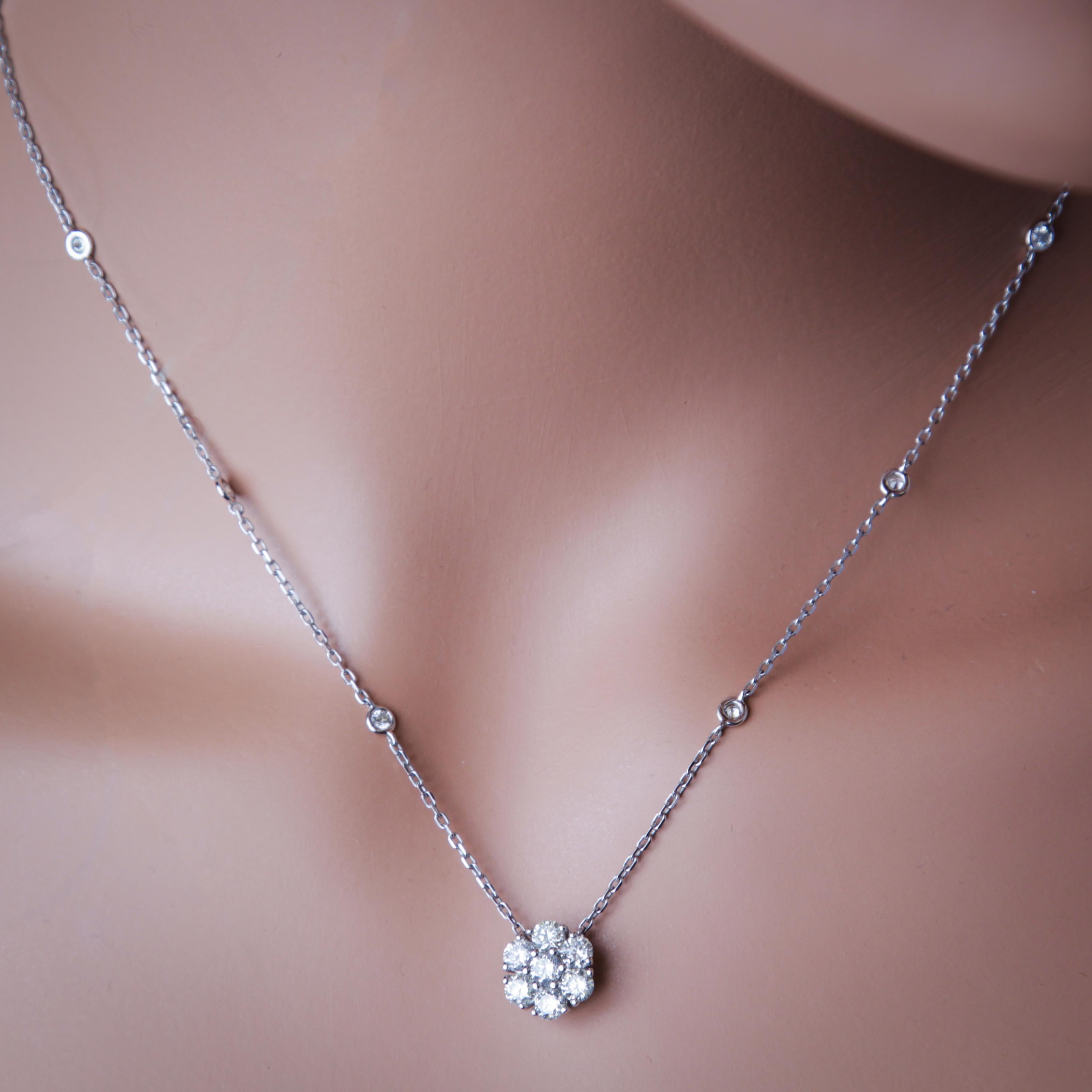 Introducing a captivating pendant in the form of a radiant flower, composed of seven round, natural diamonds. The beauty continues along the attached chain with an additional eight diamonds elegantly bezel-set. The combined weight of the diamonds