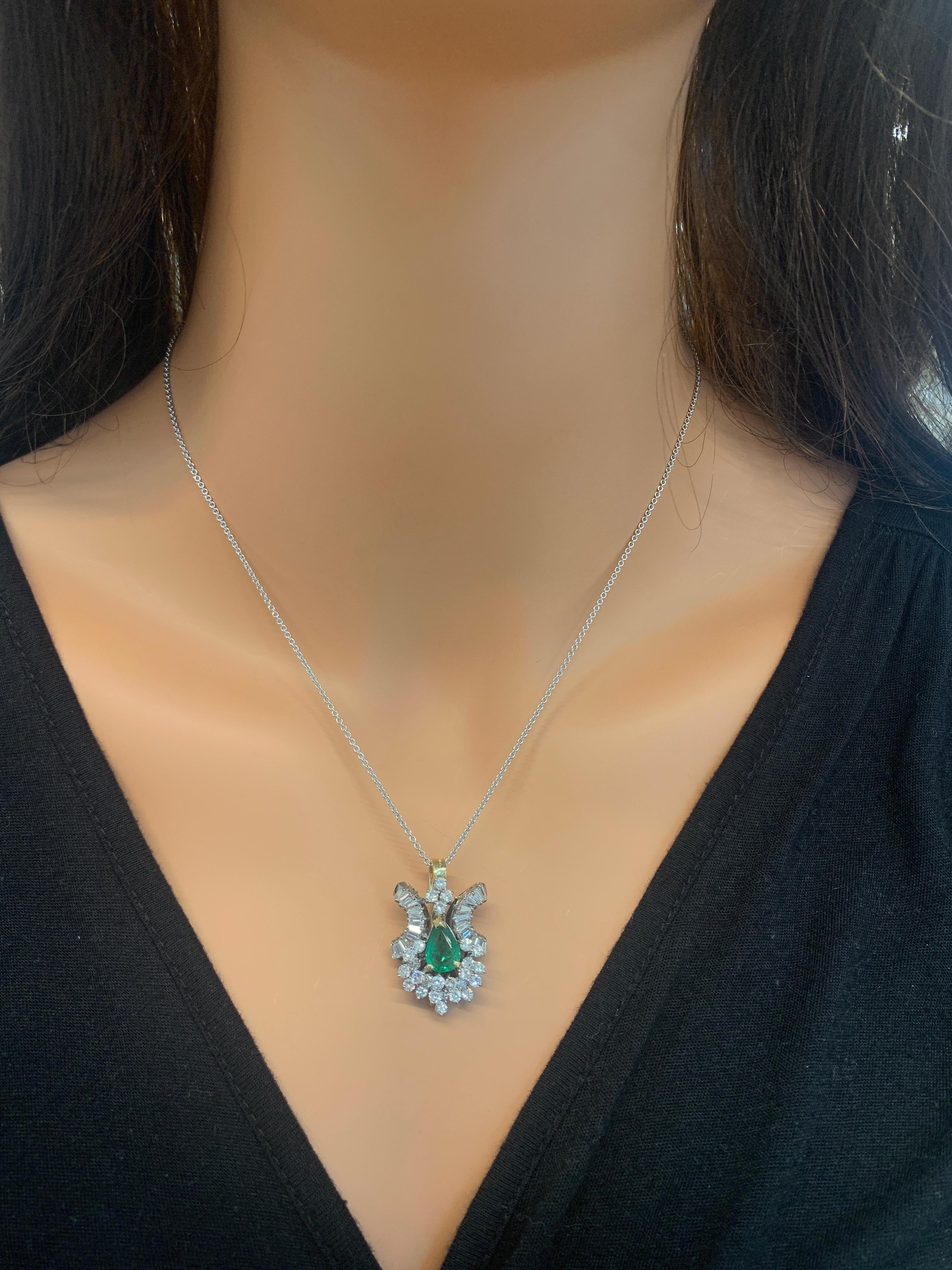 Perfect for those who appreciate vintage-style elegance. This enchanting brightly polished 18k white gold pendant features a 0.98 carat oval cut fine quality emerald exhibiting a luscious green hue. The color of this emerald is amplified by rich