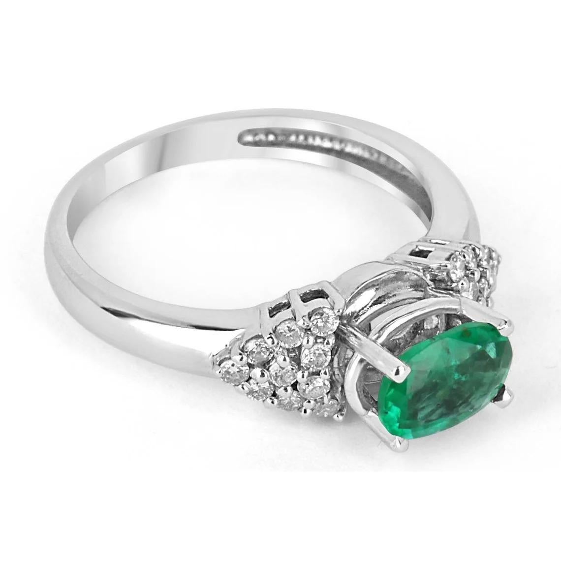 A stunning, natural Colombian emerald and diamond ring. The center stone features a 0.88-carat Colombian emerald that displays a vivacious, medium-dark green color, with excellent to very good luster. Set in a high profile, four-prong setting