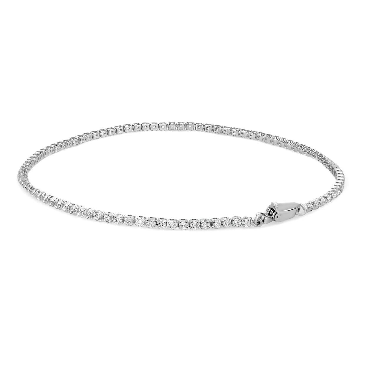 Elevate your elegance with this exquisite petite tennis bracelet, a stunning embodiment of sophistication. Crafted in 14k white gold, the bracelet showcases round brilliant cut diamonds in a prong setting style, radiating a timeless allure. Its