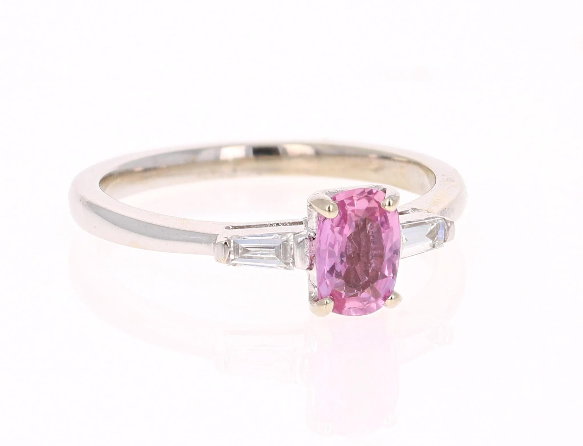 Cute Pink Sapphire and Baguette Cut Diamond Ring! 
The center Oval Cut Pink Sapphire is 0.82 Carats and is embellished with 2 Baguette Cut Diamonds weighing 0.17 Carats. The clarity and color of the diamonds are VS-H. The total carat weight of the