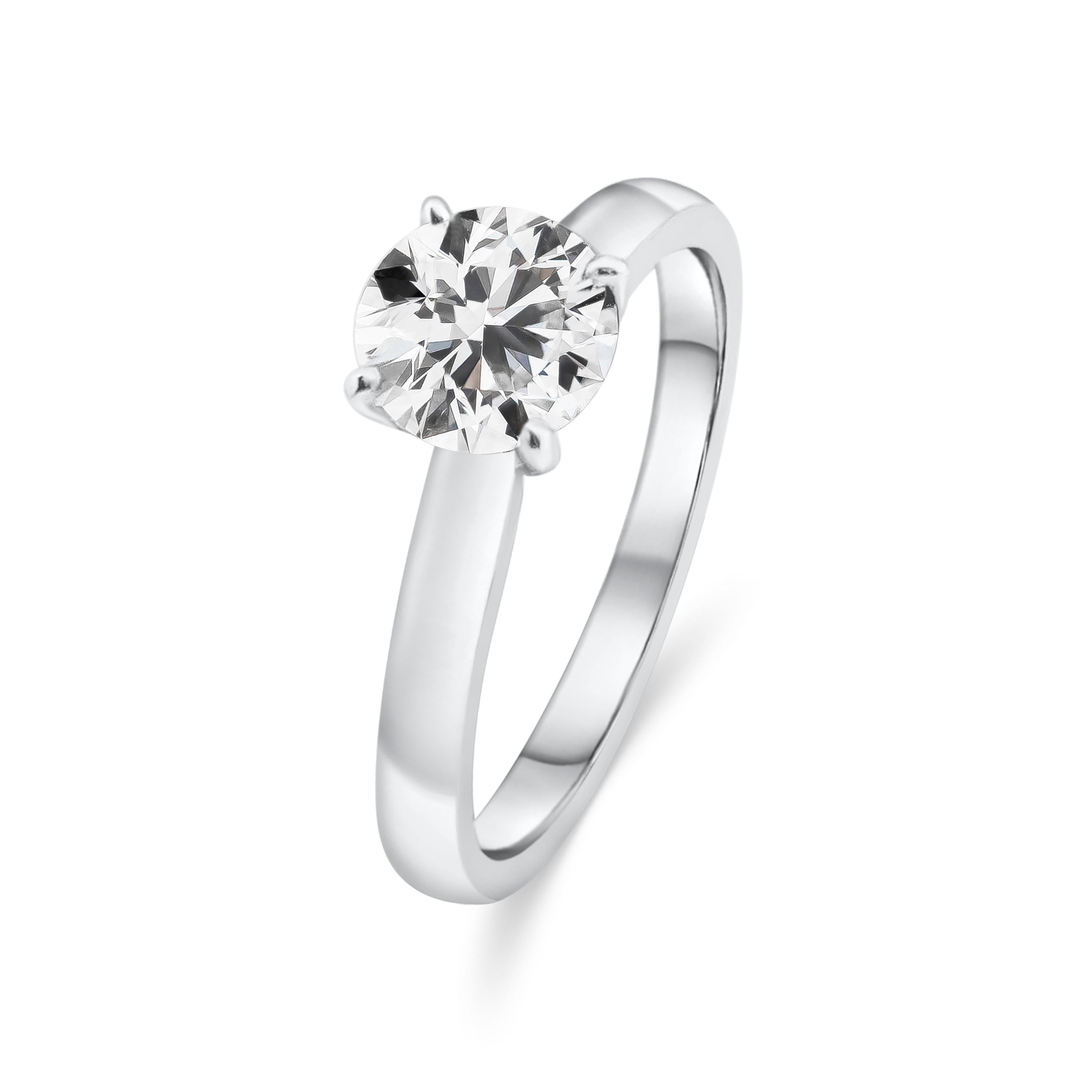 A 0.99 carat round brilliant diamond is the star of this 18 karat white gold solitaire engagement ring. Set in a 4 prong basket on an angular band made in white gold. A timeless piece.

Style available in different price ranges. Prices are based on