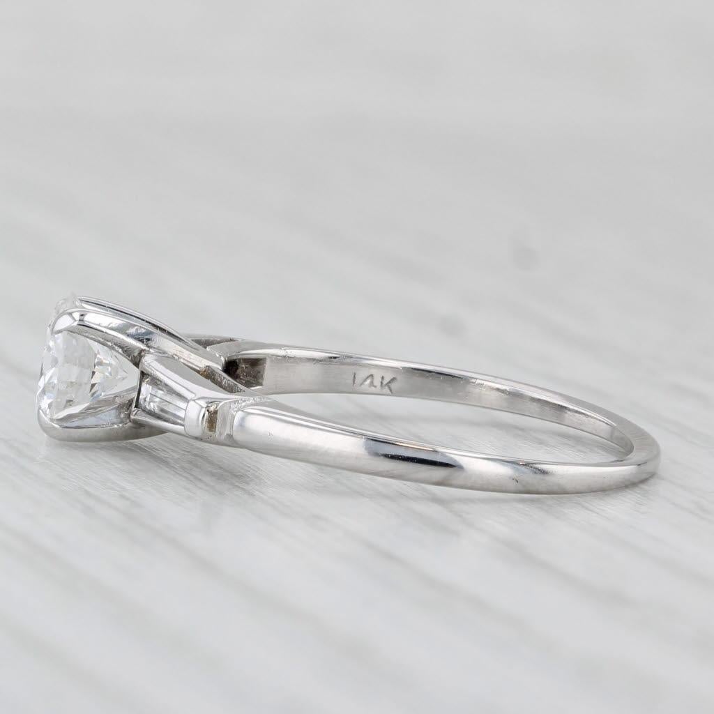 Gemstone Information:
- Natural Diamond -
Carats - 0.83ct (6.2 mm)
Cut - Round Brilliant
Color - G
Clarity - VS2

- Natural Diamonds -
Total Carats - 0.16ctw
Cut - Baguette
Color - G - H
Clarity - VS2

Metal: 14k White Gold
Weight: 2.7 Grams