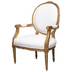 0ne of a Pair of Identical Louis XVI Style Gilt wood Armchairs