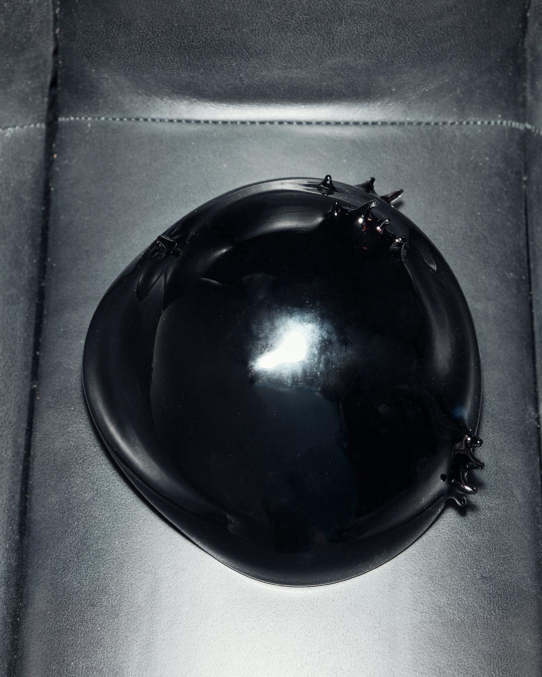 Bowl made of black blown glass. Why not make a bowl version of the 1,000,000 Dead Hippies Lamp’s shade ? That’s what capitalism taught us. Part of the Acid Mantra collection, this piece loosely represents an acid trip in a West Berlin squatt in