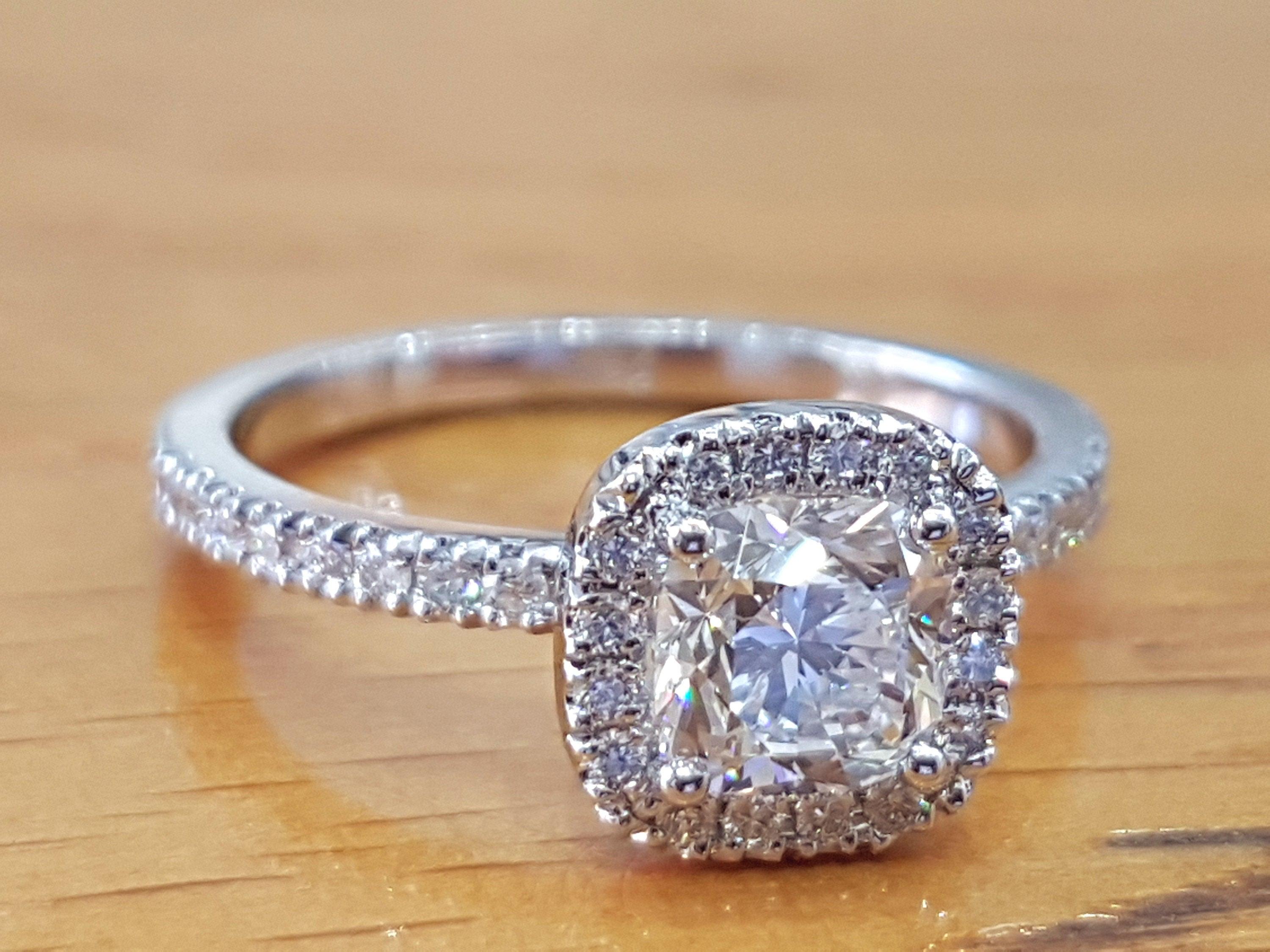 A beautiful handmade engagement ring. The center diamond of this ring is 1.50 CT, SI1 clarity and F color. The total carat weight of this diamond promise ring is 2.00 carat. This ring can be set with any stone you choose or in any carat weight. Your