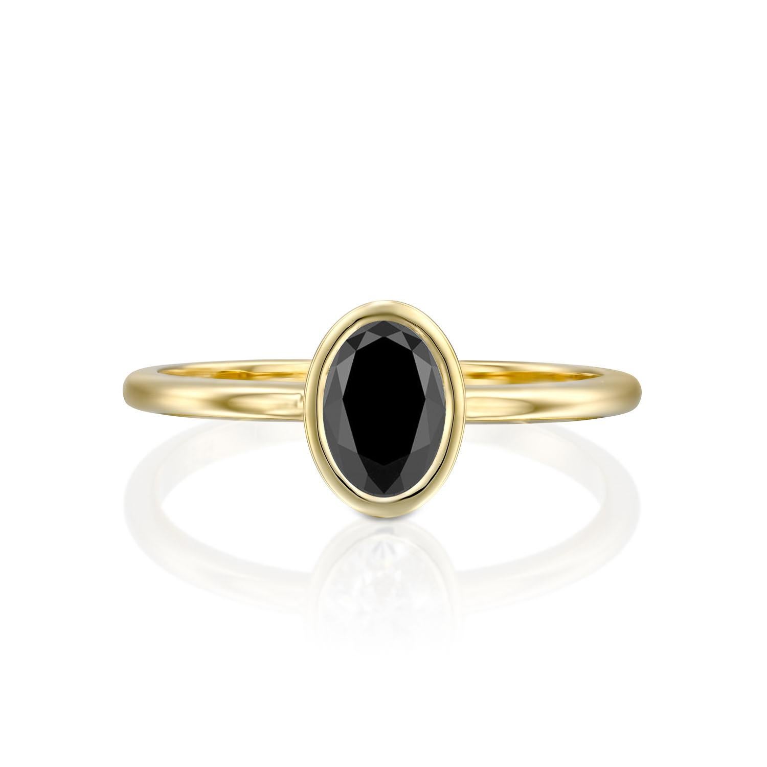 Beautiful minimalistic style black diamond engagement ring ring. Center stone is of 1.5 carats, natural, oval shaped, AAA quality Black diamond. Set in a sleek, 14K yellow gold, solitaire ring with a bezel setting. The setting looks delicate but is