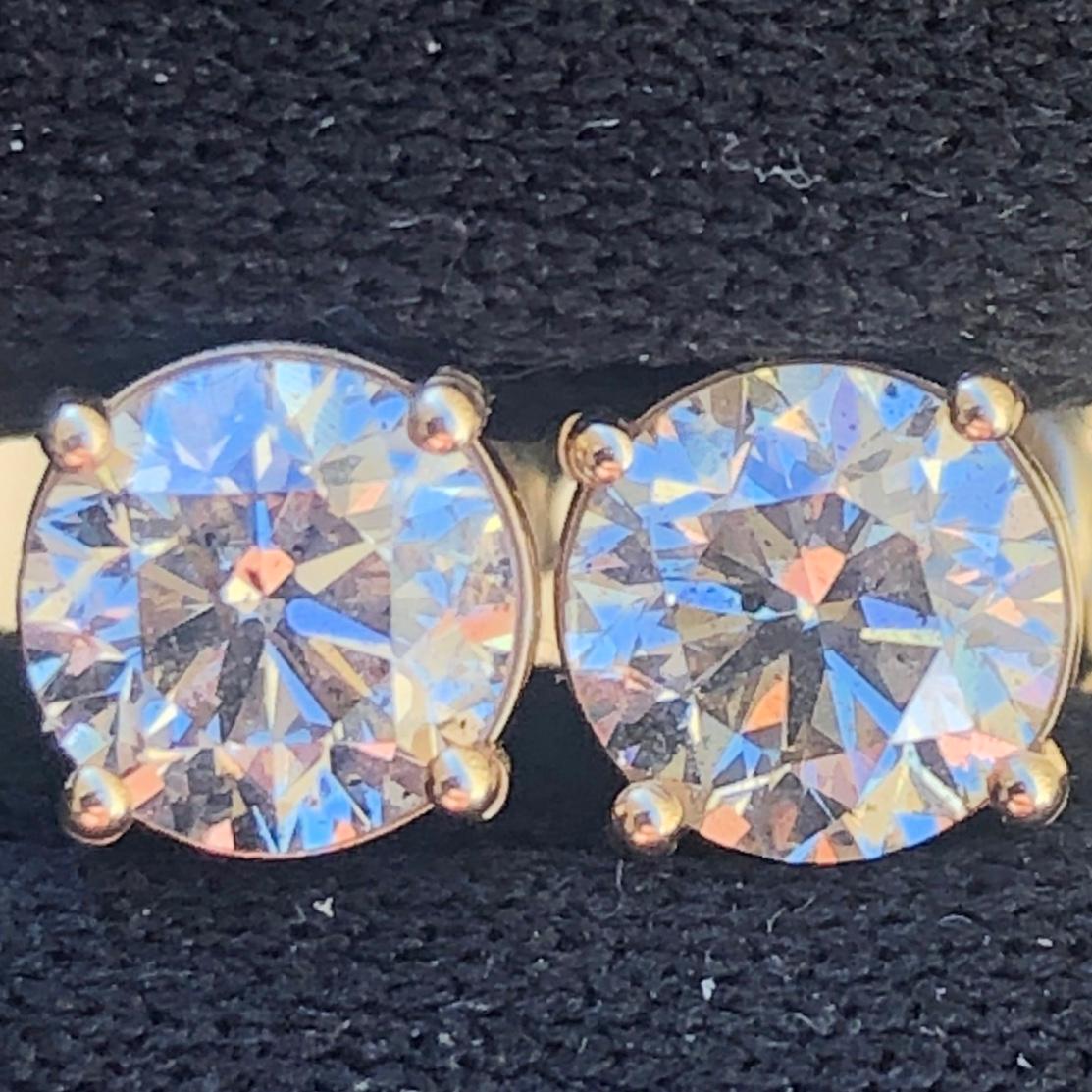 Stunning 1 1/2 Ct Round Solitaire Diamond Stud Earrings Set in 14K Yellow Gold. These natural diamond solitaire studs are certified with an appraisal value of $4,490.00.

A large center solitaire diamond (size of an engagement ring) is set on each