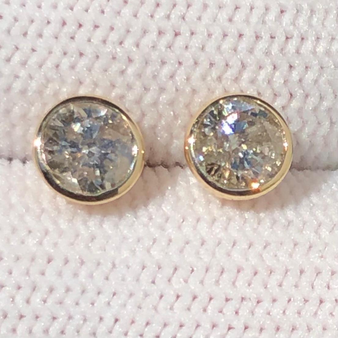 Stunning 1 1/2 Ct Round Solitaire Diamond Stud Earrings Bezel Set in 14K Yellow Gold. These natural diamond solitaire studs are certified with an appraisal report value of $7,470.00.

A large center solitaire diamond (size of an engagement ring) is