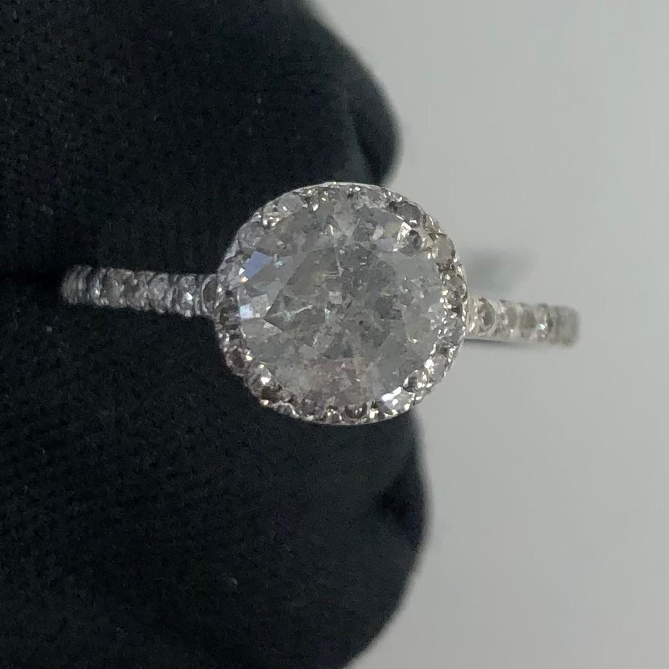 Beautiful 1.57ct round brilliant diamond halo engagement ring in 14k white gold. The center natural diamond is certified by IGL with an estimated value of $3,313.00. A 1.05 carat round solitaire diamond, graded SI3 (Natural Diamond Earth Mined