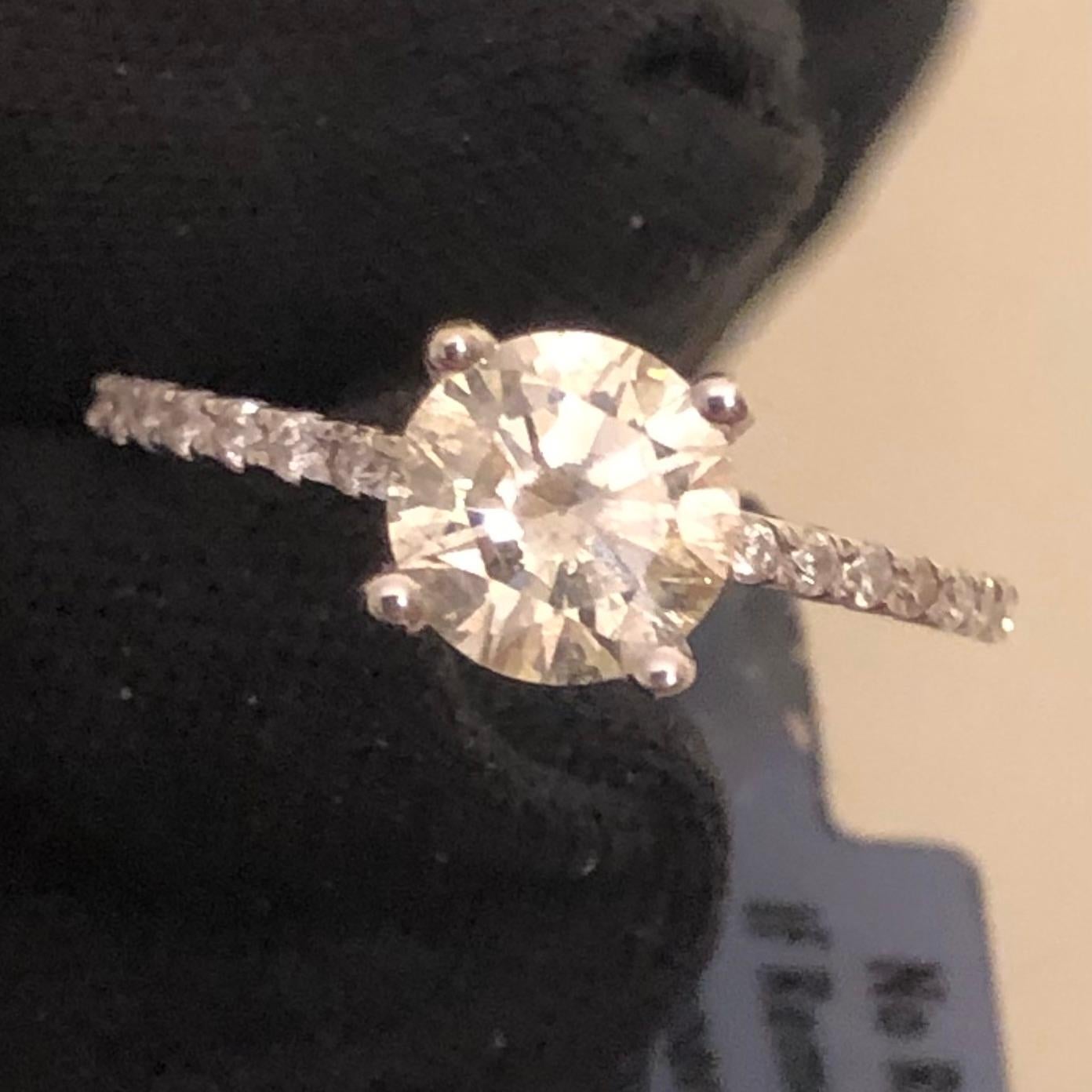 Classic 1 1/3 Ct brilliant round solitaire diamond halo engagement ring in 14k white gold. The center natural diamond is certified by GAI with an appraisal value of $4,125.00.

An over 1 carat solitaire round diamond, graded SI3 clarity (natural