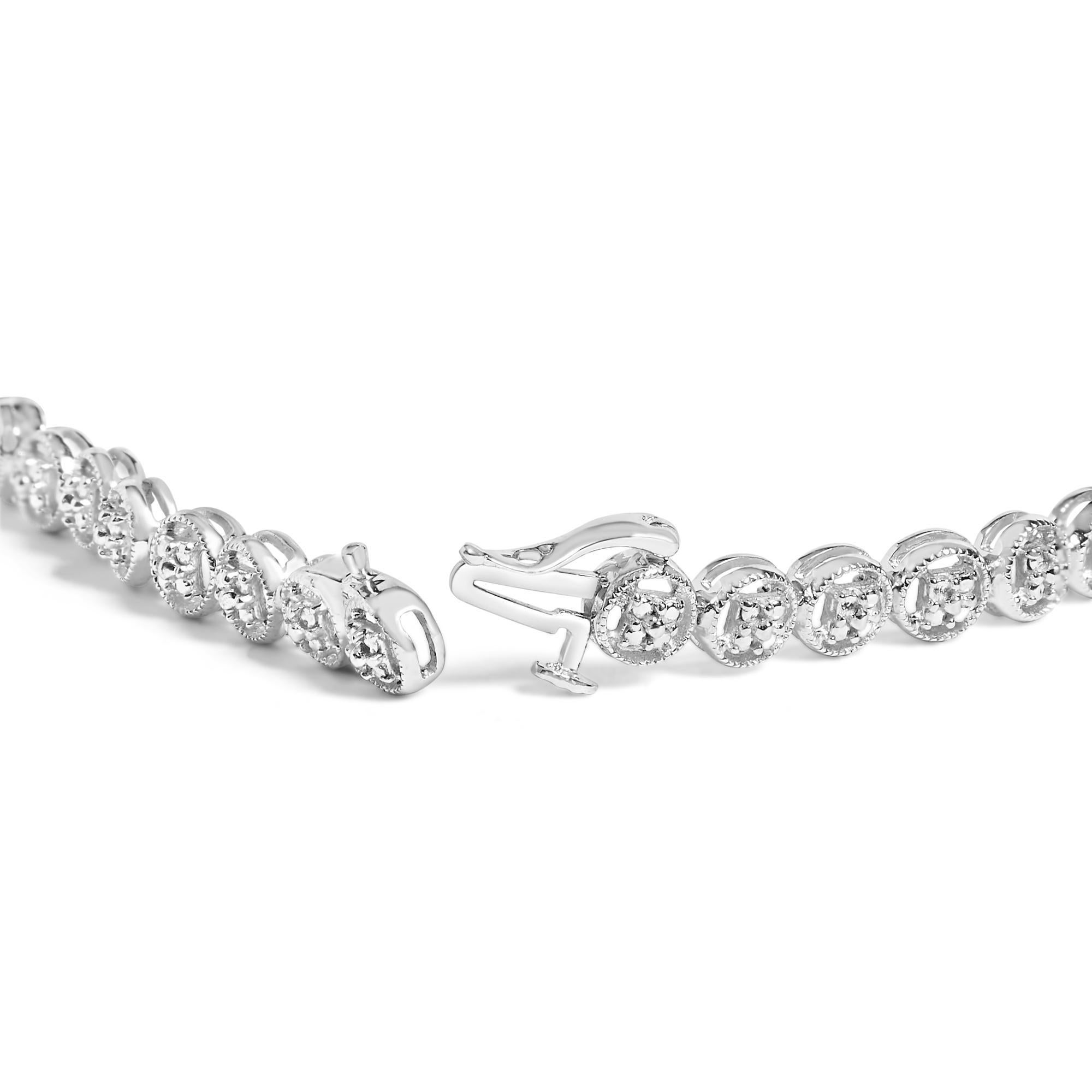 Imbued with the glow of impeccable .925 sterling silver, this tennis bracelet marries modern sophistication with a whisper of vintage charm. Each link features a lustrous open circle, cradling a natural diamond with I-J color and I3 clarity,