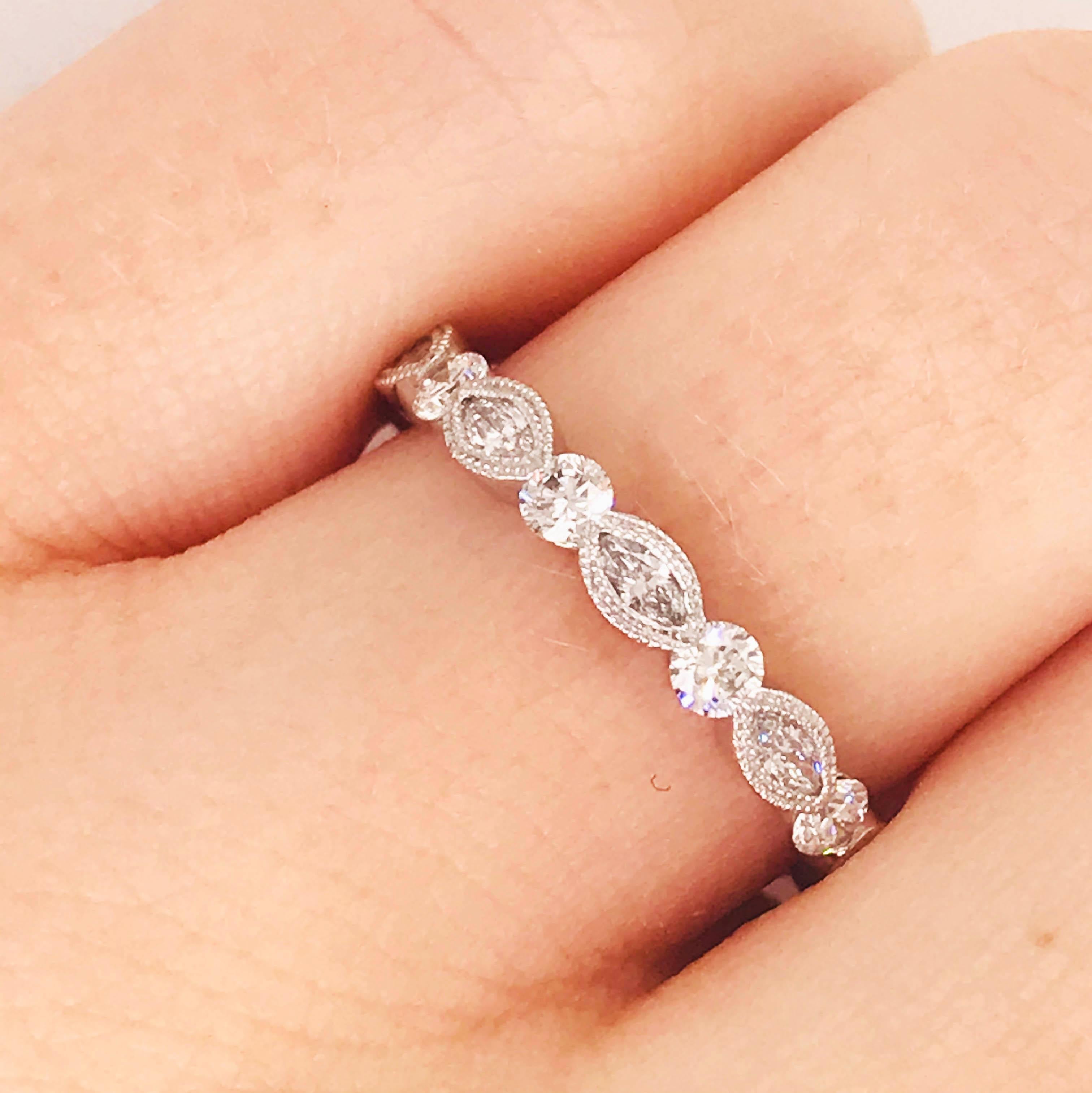 This is a bright 18k white gold 1/2 carat diamond band! With marquise diamonds set in a hand beaded bezel setting in between round brilliant diamonds. This band has a diamond pattern that goes 3/4 around the ring. The diamonds are top quality, F-G