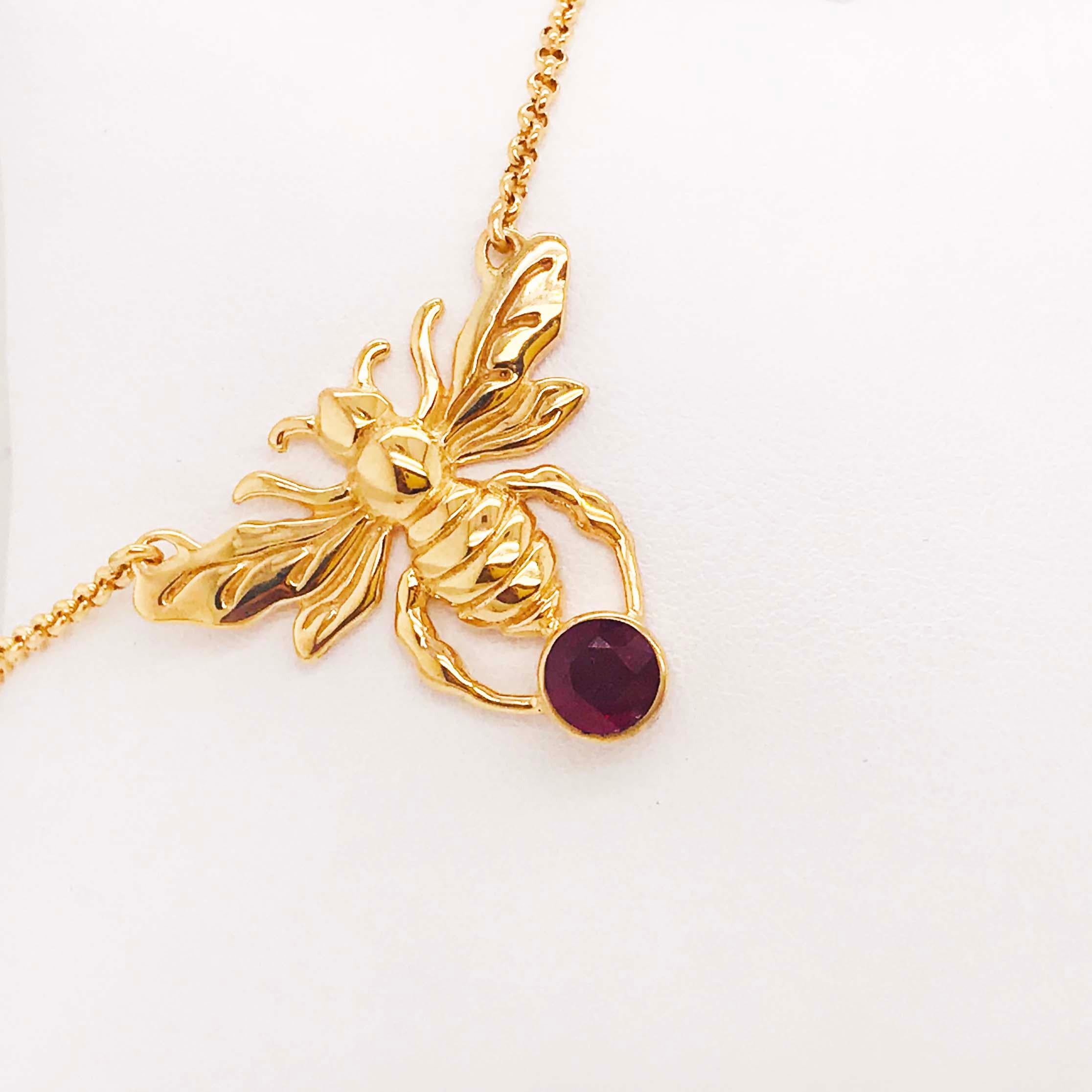 The gold ruby bee necklace is a statement piece! With a large, handmade bee that has fantastic detail work. The bee has it's wings spread wide and it is holding a genuine ruby gemstone. The ruby gemstone is a genuine gemstone that has a round