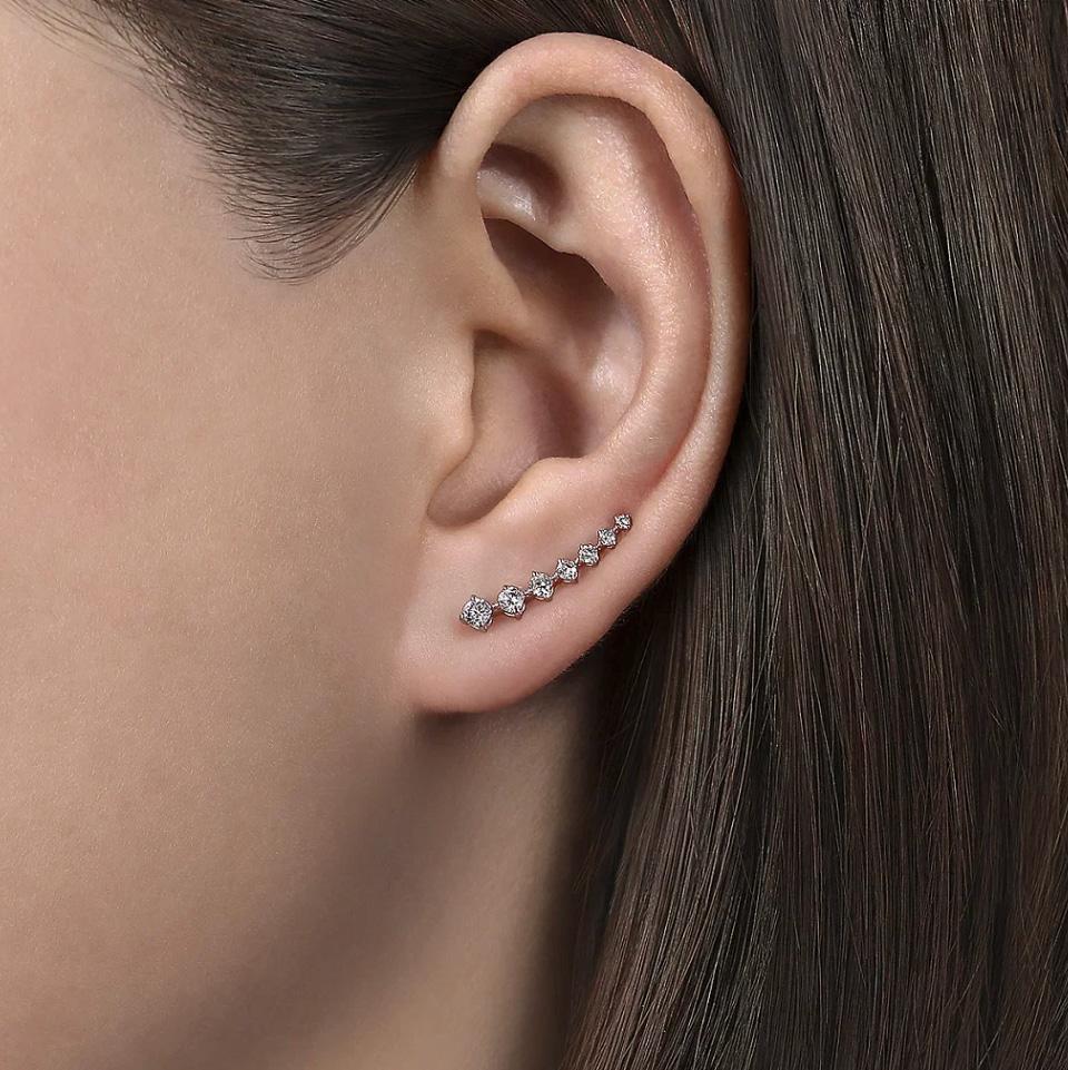These beautiful diamond and white gold ear climbers feel supremely comfortable and add a dazzle to your ears. Ear climbers are a newer jewelry trend, yet they look both stylish and classic! At 3/4 inch long, these graduated diamond earrings are a