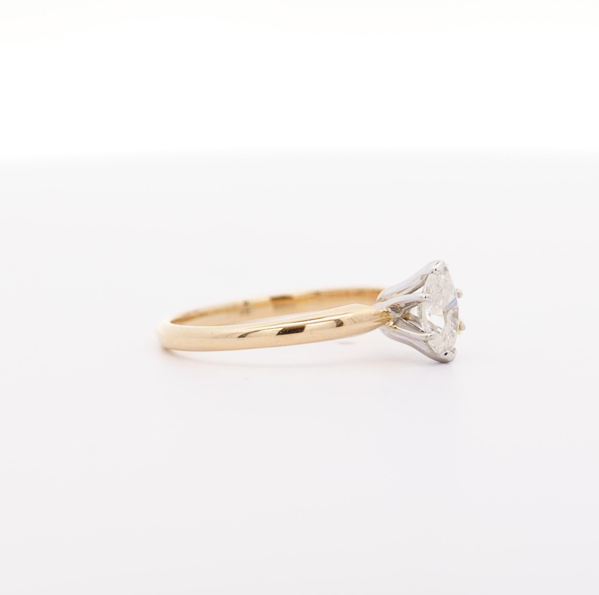 0.56 Carat 2-tone Diamond Solitaire Ring in 14K Solid Yellow Gold Band and White Gold Basket. Eye clean center stone. Marquise cut natural diamond, prong setting, with a shiny and polished finish. Ideal for an engagement ring and would pair and