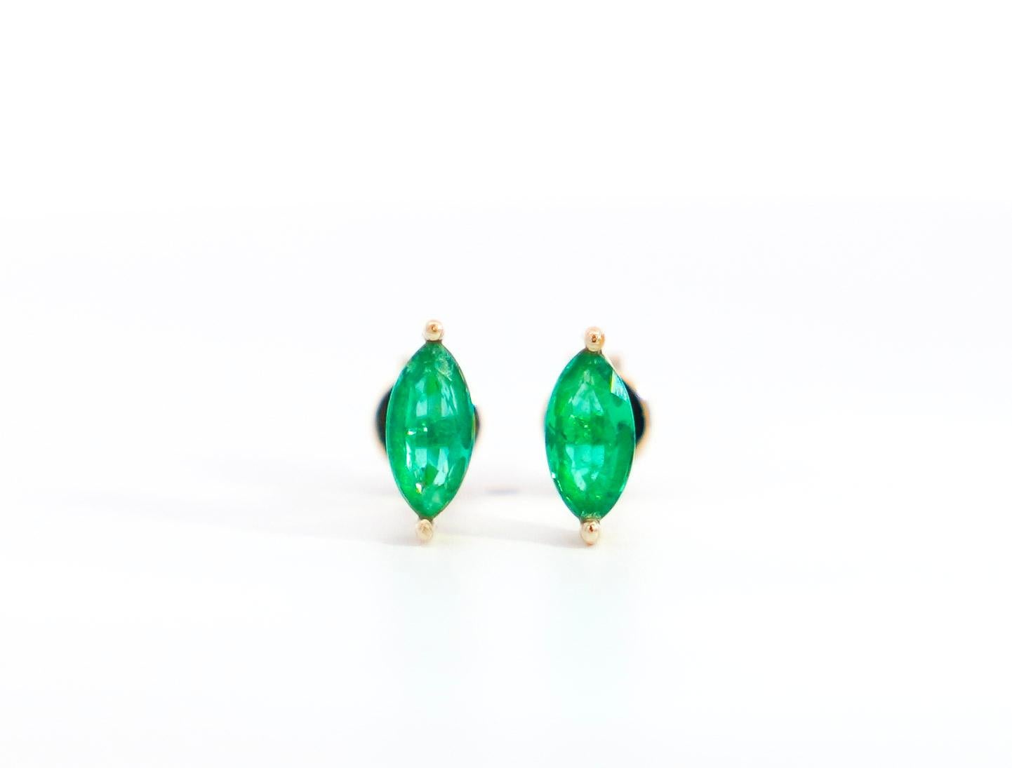 Natural Green Emerald Stud Earring, Set in 14K Yellow Gold. 

Push back stud earrings with a prong set of vivid green marquise-cut natural emeralds. With push back closure and a minimalist low basket setting, these are the ideal stud earrings for