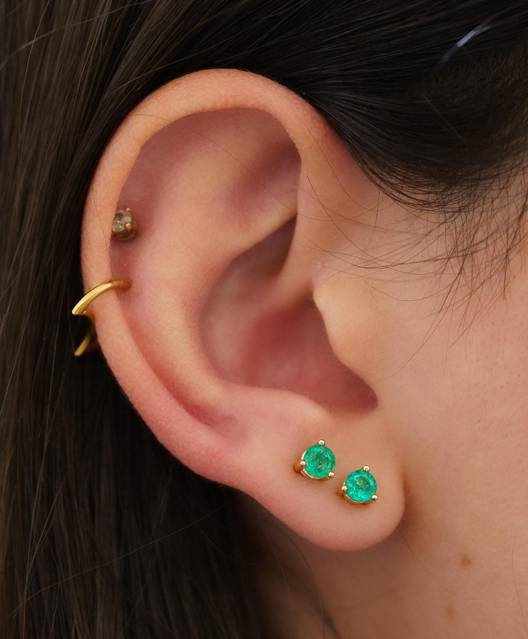 Natural emerald stud earrings in 14 karat solid yellow gold. The real thing, for the best price. 

Simple and elegant natural emerald basket stud earrings set in 14k solid yellow gold for long-lasting and durable use. Push back butterfly closure
