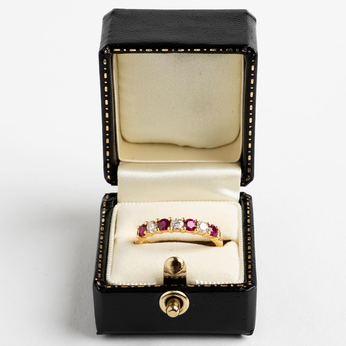 
Our beautiful and recent half eternity ring features round brilliant cut diamonds (est. .29ct) and rubies (est. .47ct) , with a 18k yellow gold band hallmarked London, 2017. The ring size is M.

A unique piece within our carefully curated Vintage &