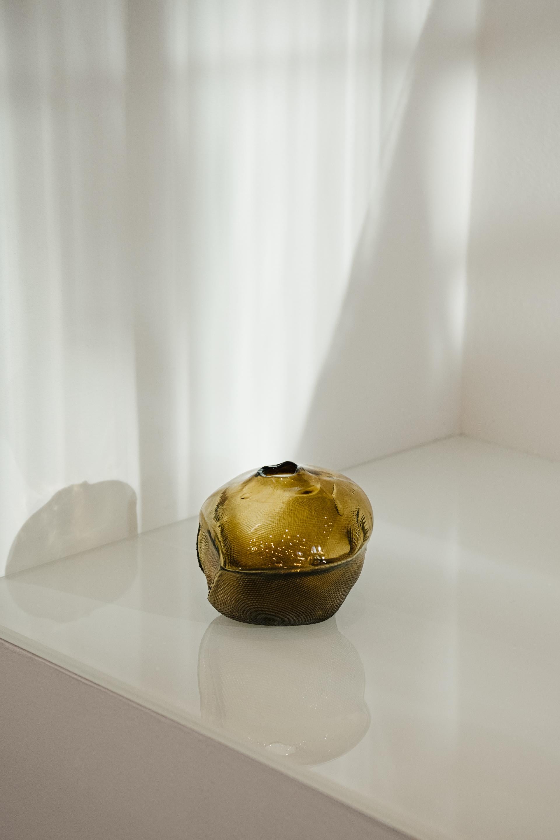 1/2 Ltr Forms Gold Blown Glass Unique Decorative Object by Vogel Studio
One Of A Kind
Dimensions: Ø 13 x H 13 cm.
Materials: Hand-blown glass.

Every glass object is blown, deformed, and polished by hand in Sweden,
Denmark or Germany. The glass