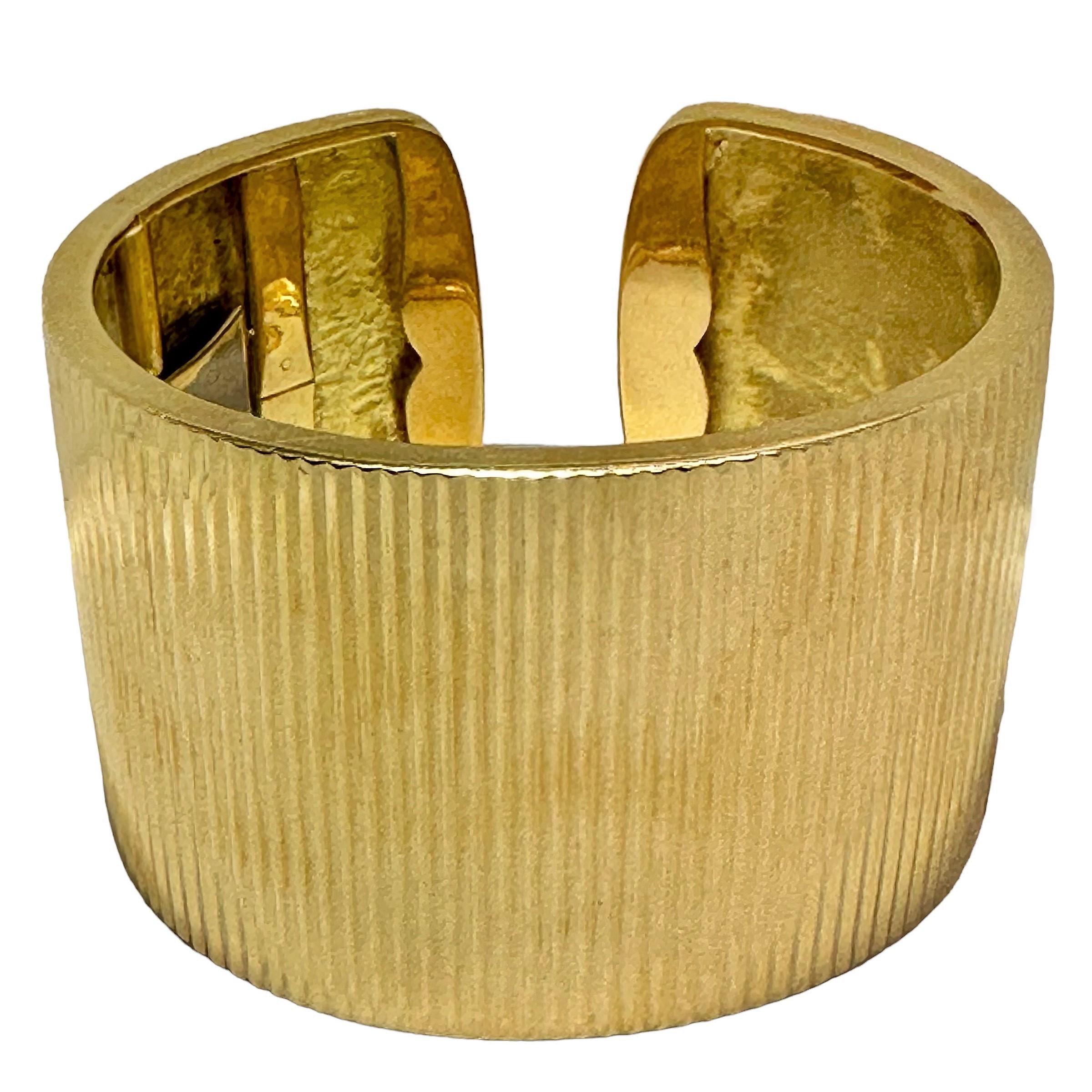 This outstanding 18K yellow gold vintage bracelet measures a full 1 3/4 inches wide at the center and is finished vertically in deep, pointed beveling over it's entire surface. This is a wonderful example of how fine gold cuffs used to be made.
