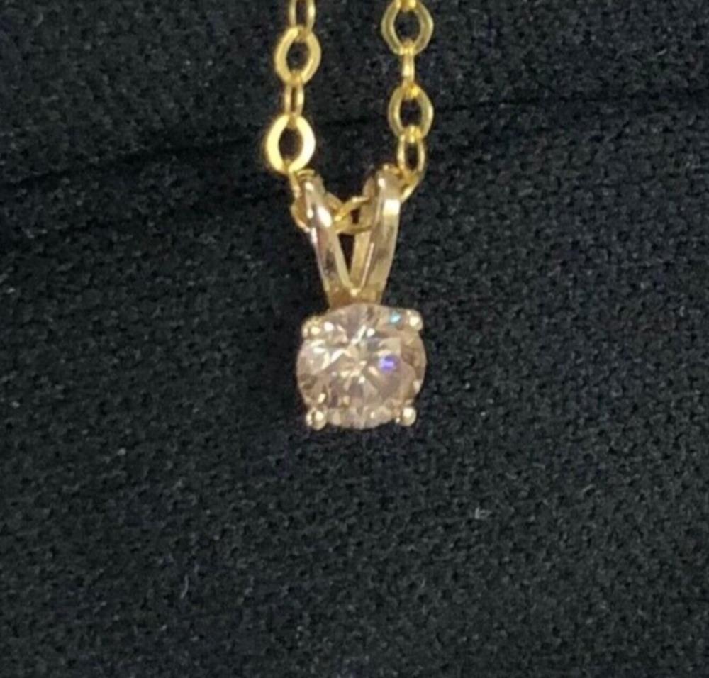 Classic approx. 1/3 carat solitaire round diamond pendant in 14k yellow gold with necklace chain. A center brilliant round diamond weighing approx. 1/3 carat (natural earth-mined diamond) is set in a 4-prong basket.

Diamond solitaire pendant in 14k